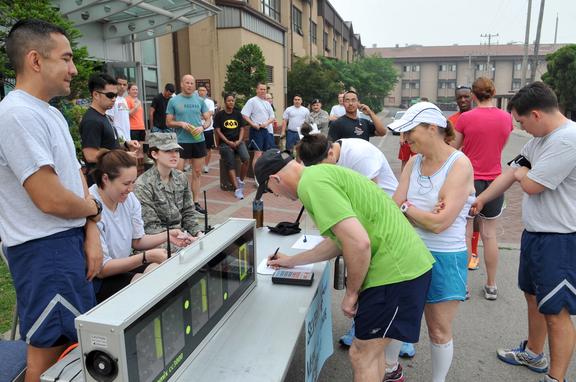 Airmen register for the Medal of Honor recipient 5K run at Osan Air Base, Republic of Korea, June 6, 2013. The run, organized by the 7th Air Force company grade officer’s organization, highlighted 7th AF history while providing an opportunity to participate in a base-wide event. (U.S. Air Force photo/Tech. Sgt. Raymond Mills)