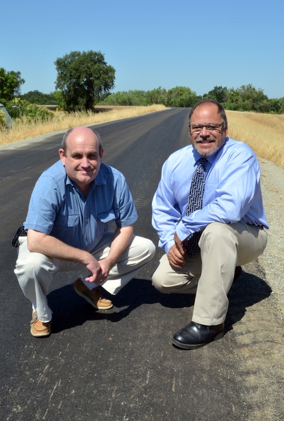 Mark Ellis, U.S. Army Corps of Engineers Sacramento District project manager, left, and John Nicoletti, chairman of the Yuba County Water Agency and member of the Yuba County Board of Supervisors, examine the fully-completed first phase of the Marysville Ring Levee project in Marysville, Calif., June 7, 2013. Pavement was added in late May over the top of structural reinforcements completed in December 2012. Pavement was delayed by the onset of winter rains. (U.S. Army photo by Robert Kidd / Released)