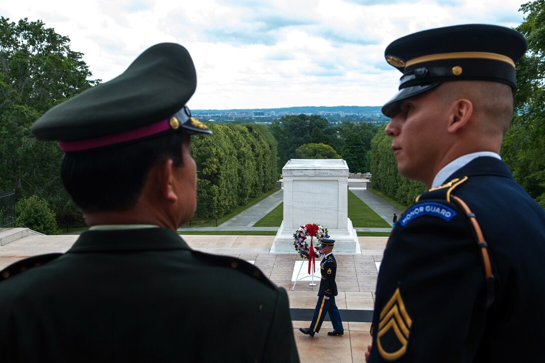 U.S. Army Staff Sgt. Michael Buelna, right, explains the changing of the guard at the Tomb of the Unknown Soldier to Thai army Gen. Prayuth Chan-Ocha, the Thai army's commander in chief, at Arlington National Cemetery, Va., June 6, 2013.