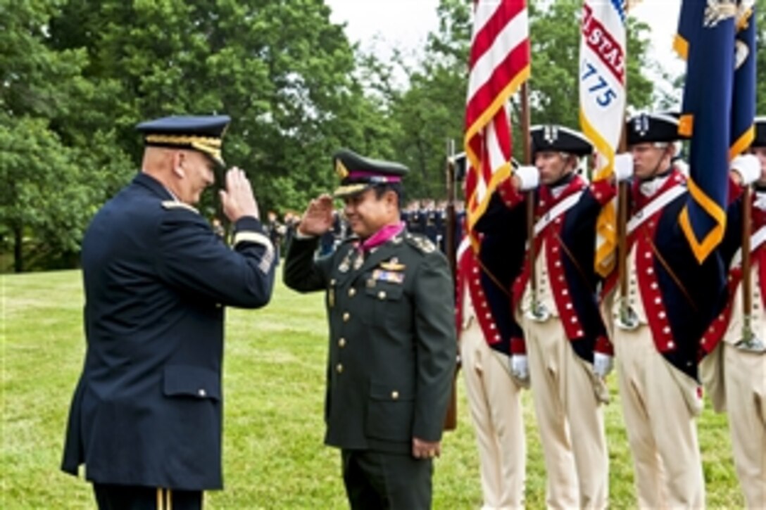U.S. Army Chief of Staff Gen. Ray Odierno, left, salutes Thai army Gen. Prayuth Chan-Ocha, the Thai army's commander in chief, after presenting him the Legion of Merit during an Army full-honors ceremony at Whipple Field on Joint Base Myer-Henderson Hall, Va., June 6, 2013. 