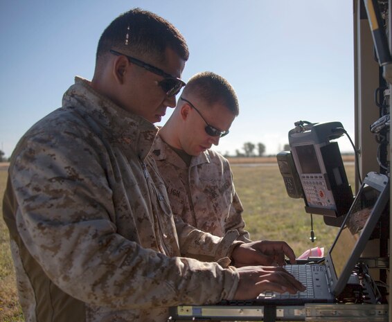 130520-M-WB921-027 MORON DE LA FRONTERA, Spain -- Corporal Cristobal Gomez, front, a Special-Purpose Marine Air-Ground Task Force Crisis Response satellite technician and San Antonio native, and Sgt. Justin Hofelich, SP-MAGTF Crisis Response satellite communication chief and Madison, Ind. native, prepare a Very Small-Aperture Terminal Large Satellite aboard Moron Air Base, May 20. "Satellite communications allow reliable and efficient communication support across the task force's area of responsibility, wherever we asked to go," said Capt. John Schreiner, the communications officer for SP-MAGTF Crisis Response and Sandusky, Ohio native. The SP-MAGTF Crisis Response is a rotational force of approximately 500 Marines and sailors sourced from a variety of Marine Corps units to include II Marine Expeditionary Force, Camp Lejeune, N.C., according to the force's requirement and their mission of being task organized, rapid-deployment force within the African regional reach to respond to crisis and defend U.S. security interests. (Marine Corps photo by Lance Cpl. Caleb McDonald/Not Released)
