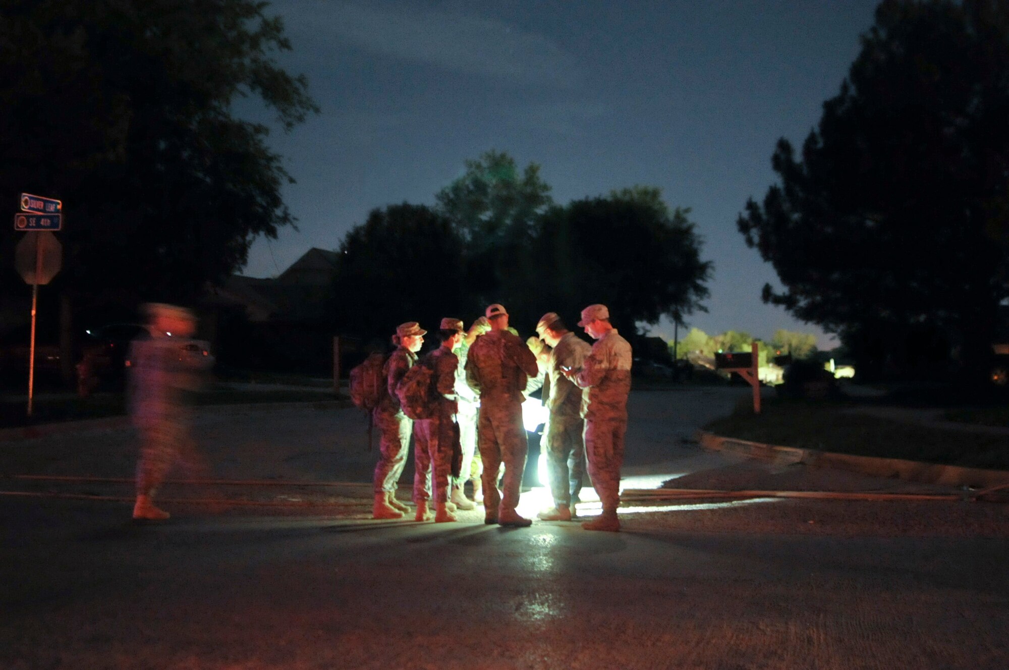 Oklahoma Army and Air National Guard conduct a shift change at a checkpoint during the night in Moore, Okla., May 22, 2013. Joint military rescue, relief and security efforts have been deployed by Oklahoma's governor, Mary Fallin, after the devastating tornado that struck May 20, 2013. (U.S. Air Force Photo by Staff Sgt. Caroline Hayworth/Released)