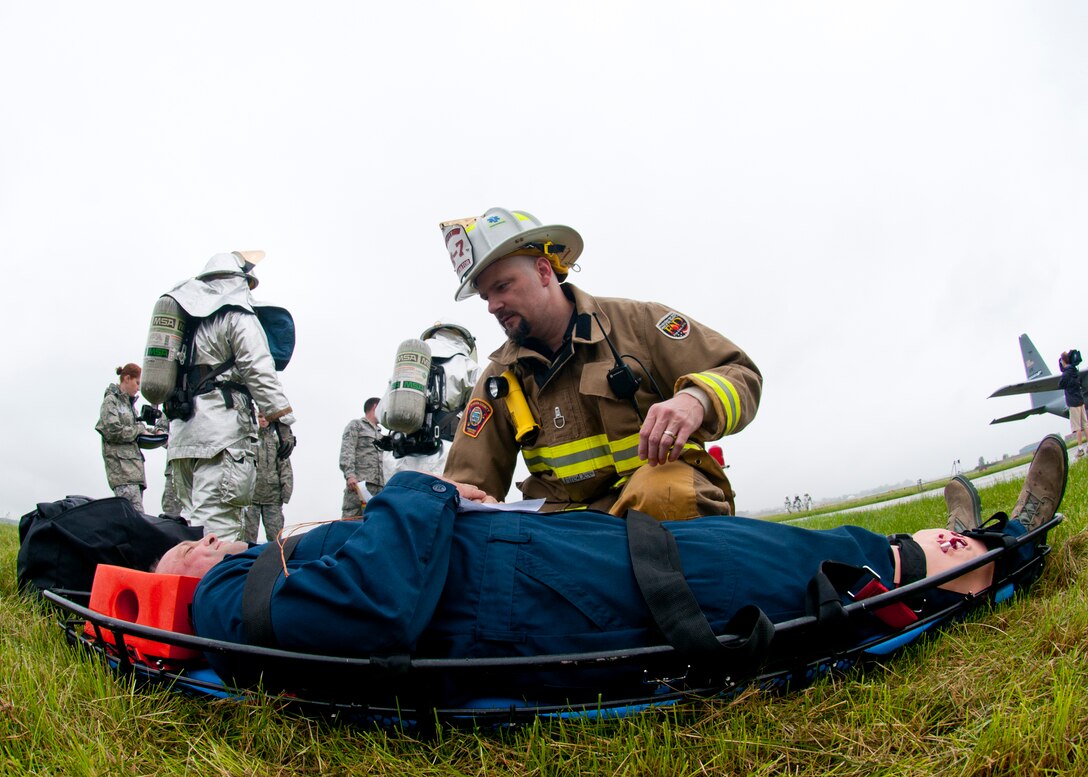 Members of the 914th and 107th Airlift Wings along with first responders from state and local agencies respond to a simulated plane crash during a Mass Accident Response Exercise at the Niagara Falls International Airport, June 8, 2013, Niagara Falls, N.Y. This exercise was designed to evaluate the capability of the Niagara Falls Air Reserve Station in responding to a hypothetical accident involving mass casualties and to evaluate the effectiveness its emergency response plan. (U.S. Air Force photo by Tech. Sgt. Joseph McKee) 