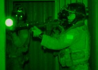 Students from the 23rd Special Tactics Training Squadron search a building for a high-value-target using night-vision goggles during an exercise on the Eglin Air Force Base range.  The exercise provided critical training in counter-insurgency tactics, land navigation and mission planning to potential Air Force combat controllers. (U.S. Air Force photo/Tech. Sgt. Cheryl Foster)