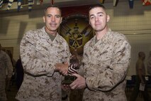 Brig. Gen. Paul K. Lebidine presents Maj. Timothy J. Humphreys with the 2012 Jim Kallstrom Leadership Award following 4th Law Enforcement Battalion's activation ceremony June 8. The unit officially reactivated Sept. 26, 2012. Lebidine assumed command of Force Headquarters Group, Marine Forces Reserve, in August 2012. For additional imagery from the event, visit www.facebook.com/rstwincities.