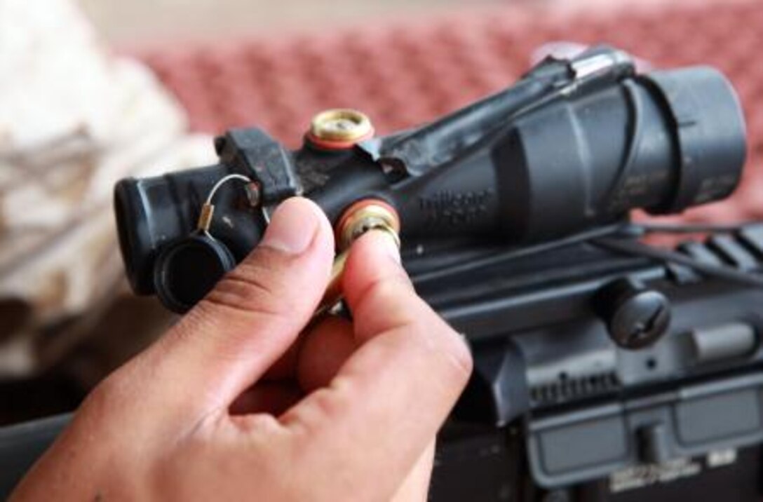 A Marine with Lima Company, 3rd Battalion, 3rd Marine Regiment, Marine Rotational Force – Darwin, adjusts the sights on his rifle before participating in a poker-shoot competition, here, May 16. During the competition, both Marines and soldiers with 12th Platoon, Delta Company, 5th Battalion, Royal Australian Regiment, fired at playing cards, trying to get the better hand.
