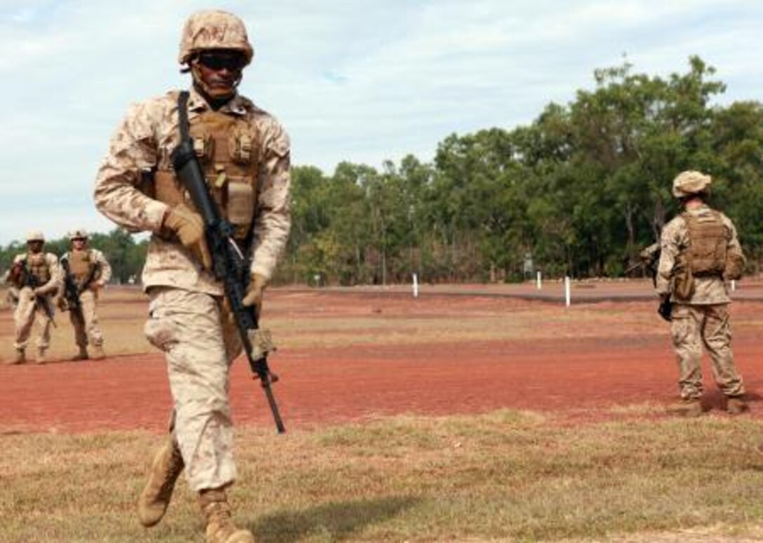 Lance Cpl. Frank Smith, Weapons Platoon, Lima Company, 3rd Battalion, 3rd Marine Regiment, Marine Rotational Force – Darwin, sprints to the firing line during a poker-shoot competition, here, May 16. Before competitors engaged their targets, they had to execute five squats, sprint to the firing line and complete five push-ups.
