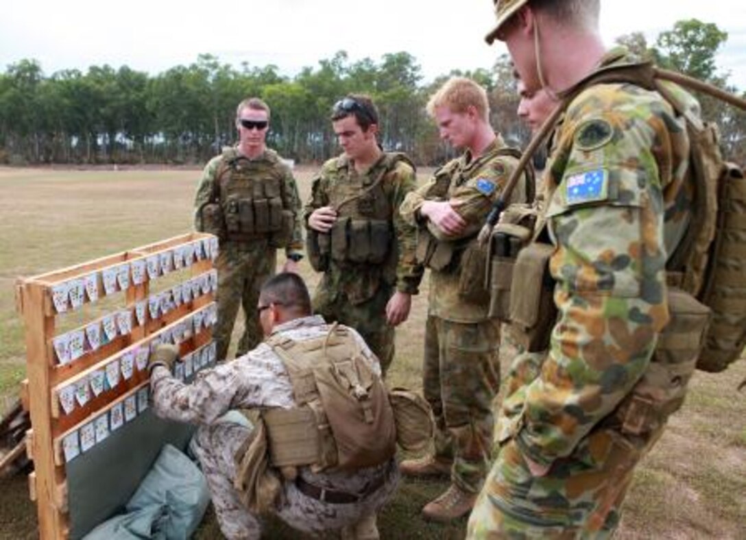 Staff Sgt. Joseluis Mejia, platoon sergeant, 1st Platoon, Lima Company, 3rd Battalion, 3rd Marine Regiment, Marine Rotational Force – Darwin, scores the shots fired by the Australian soldiers during a poker-shoot competition, here, May 16. The rules of poker applied to the shoot, and the team who shot the best hand advanced to the next round.