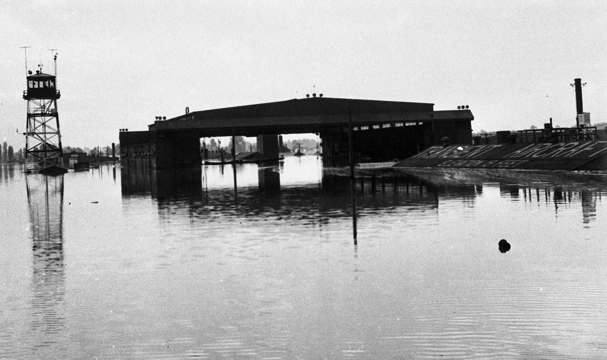 On Memorial Day, May 30, 1948, the Vanport flood engulfed the Portland Air National Guard Base, Portland, Ore. This image depicts the flooding effects of one of the base hangars several days after the flood waters breached the Columbia River. (Oregon Air National Guard historical photo). 