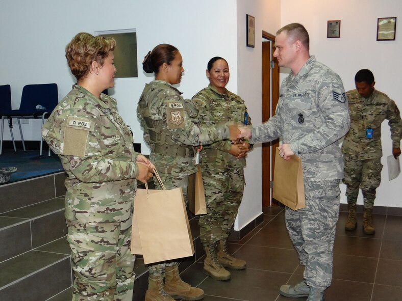 U.S. Air Force Staff Sgt. Matthew Jacobs, 139th Security Forces Squadron (SFS), Missouri Air National Guard, shakes hands with service members of the Panamanian Public Forces (PPF) in Panama City, Panama, May 16, 2013. SFS Airmen conducted an exchange of information with the PPF. (U.S. Air National Guard photo by Airman 1st Class Marina Salazar/Released)