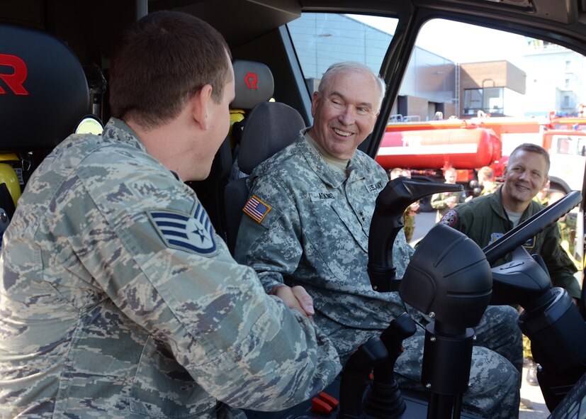 U.S. Army Maj. Gen. James Adkins, the Adjutant General for the Maryland National Guard, thanks U.S. Air Force Staff Sgt. Joshua, McDaid, working as a firefighter for the 175th Wing, Maryland Air National Guard, for telling him about the Estonian Rosenbauer CA5 Panther at the fire station at Amari Air Base, Estonia , June 5, 2013, during Saber Strike. Gen. Adkins traveled to Estonia to celebrate 20th anniversary of the state partnership program between the Estonian Military and the Maryland National Guard.  Saber Strike 2013 is a U.S. Army Europe-led, multinational, tactical field training and command post exercise occurring in Lithuania, Latvia and Estonia June 3-14 that involves more than 2,000 personnel from 14 different countries. The exercise trains participants on command and control as well as interoperability with regional partners and is designed to improve  joint, multinational capability in a variety of missions and to prepare participants to support multinational contingency operations worldwide. (U.S. Air National Guard photo by Staff Sgt. Benjamin Hughes)