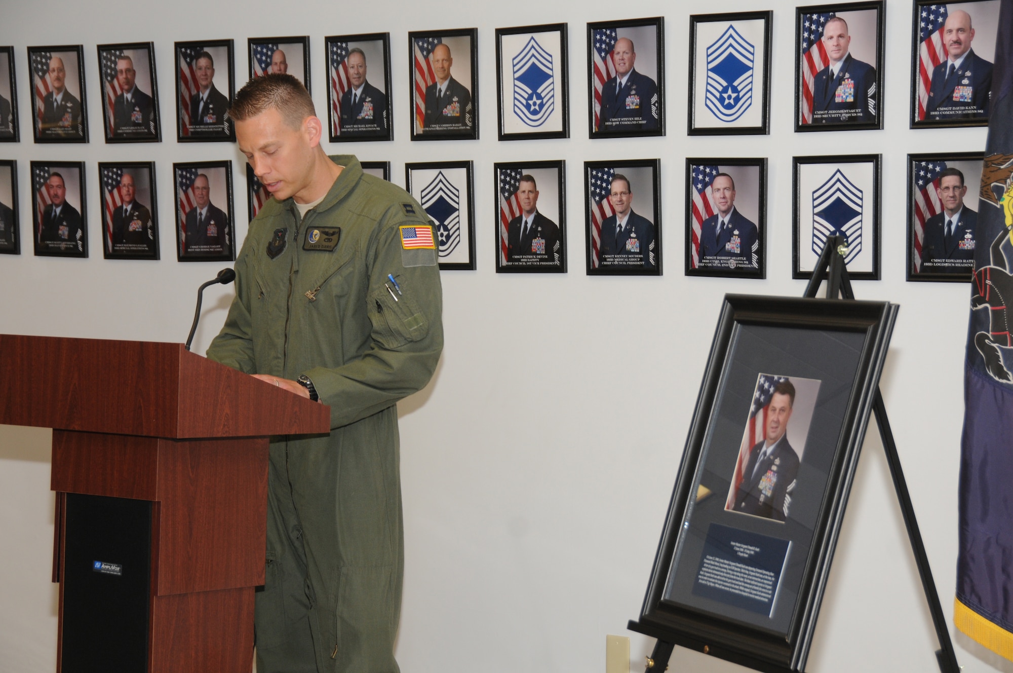 Capt. Jared Davis reads the citation of Senior Master Sgt. Donald Koch, who was inducted into the 193rd Special Operations Wing Hall of Honor, June 8.  The wing unveiled and inducted three wing Airmen into the Hall of Honor to include, the late Staff Sgt. Ricky Yiengst, retired Tech. Sgt. Phillip Myers and Sergeant Koch. These individuals were inducted into the hall for extraordinary events they were part of and outstanding contributions they made, bringing honor and prestige to the 193rd. (U.S. Air National Guard photo by Senior Airman Claire Behney/Released)