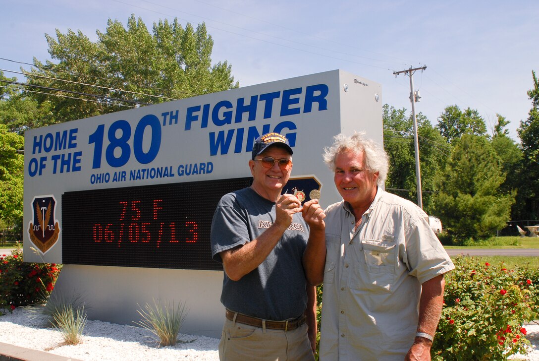Mr. Duke Wheeler and retired U.S. Air Force Lt. Col. Bob Holliker, the men behind the design and production of the special Military Brat challenge coins. The intent is to give the coins to each veteran attending the events in June so that they may present the coins to their children as a sign of their appreciation. Photo by Master Sgt. Elizabeth Holliker, Public Affairs (Released).