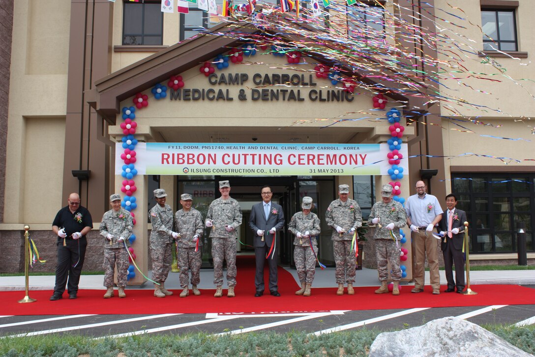 A dozen military and civilian officials including U.S. Army Garrison Daegu commander Col. Kathleen Gavle, Far East District commander Col. Degidio and Col. Bryan Green, 168th Multifunctional Medical Battalion commander, Lt. Col. Cornes, and Ilsung construction company president Oh, Sae-Ick cut the ribbons during the turn over ceremony at Camp Carroll May 31. This facility will provide state of the art medical and dental care for soldiers. 