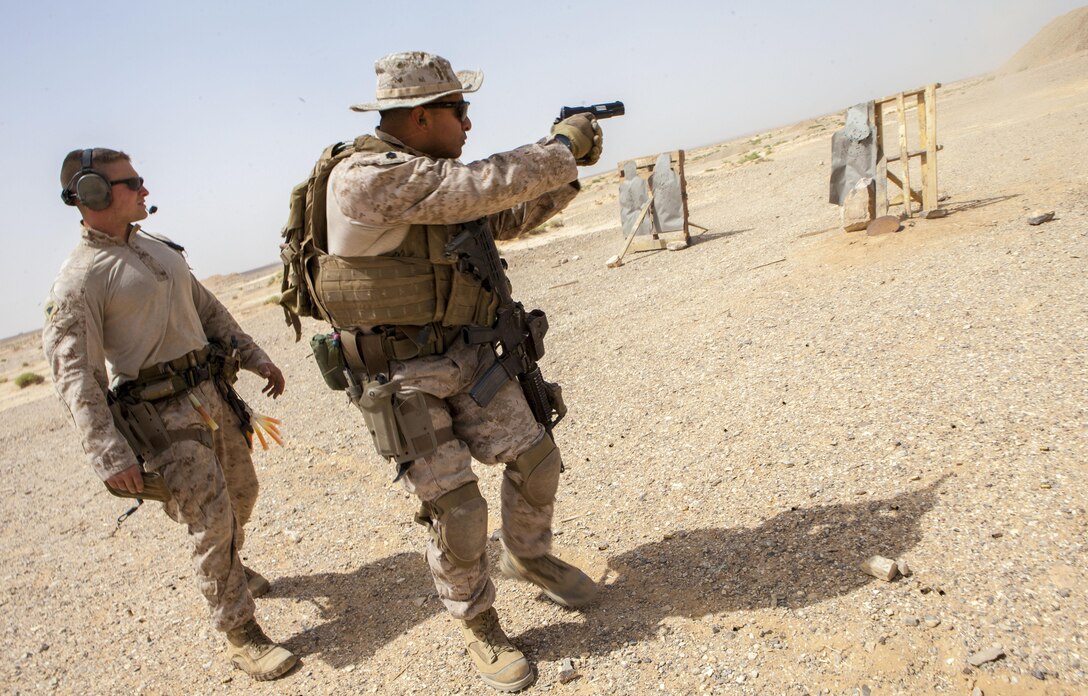 A 26th Marine Expeditionary Unit Maritime Raid Force Marine fires an M1911 MEUSOC .45 caliber pistol at a range in Jordan, June 9, 2013. Exercise Eager Lion 2013 is an annual, multinational exercise designed to strengthen military-to-military relationships and enhance security and stability in the region by responding to realistic, modern-day security scenarios. The 26th MEU is a Marine Air-Ground Task Force forward-deployed to the U.S. 5th Fleet area of responsibility aboard the Kearsarge Amphibious Ready Group serving as a sea-based, expeditionary crisis response force capable of conducting amphibious operations across the full range of military operations. (U.S. Marine Corps photograph by Sgt. Christopher Q. Stone, 26th MEU Combat Camera/Released)
