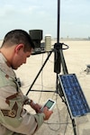 Staff Sgt. Kevin Fedon, weather forecaster from the Nebraska Air National Guard, checks weather readouts (temperature, wind speed/direction and precipitation) at a remote weather sensor at an undisclosed location in Southwest Asia Nov. 4, 2008. The weather readings are put into a weather model to help predict weather patterns and are used for daily reports to aircrews preparing for missions.