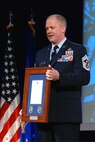 Chief Master Sgt. Christopher Muncy, command chief of the Ohio Air National Guard, holds up a Hometown Heroes Salute award that in 2009 will be given to eligible National Guard Airmen who deployed on orders for more than 30 consecutive days in a contingency operation. Muncy and Chief Master Sgt. Richard Smith, command chief of the Air Guard, announced the Hometown Heroes Salute program Nov. 20 at the Air Guard Senior Leadership conference outside Washington.