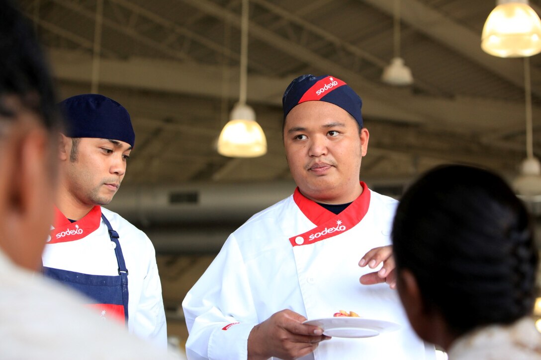 Steven Salas, a civilian cook with Marine Corps Recruit Depot San Diego mess hall, explains his team's dishes and recipes to judges during the Chef of the Quarter Culinary Competition at Camp Pendleton, June 5. Chef of the Quarter Culinary Competition at Camp Pendleton, June 5. The competition brought Marines and civilians from various bases across Marine Corps Installations West. After the single elimination knowledge-bowl, the four teams with the highest score advanced to the cooking challenge. The winners earned an opportunity to attend the Culinary Institute of America located in Hyde Park, N.Y., for six weeks.