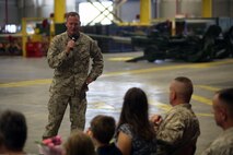 Brig. Gen. Edward D. Banta (top), the commanding general of 2nd Marine Logistics Group, says a few kind words to Col. Jeffrey M. Reagan (bottom right), the former chief of staff for 2nd MLG, and his family during a retirement ceremony at 2nd Maintenance Battalion’s maintenance bay aboard Camp Lejeune, N.C., June 7, 2013. During Reagan’s retirement ceremony, Banta spoke about their years of service together and the different duty stations they served aboard. 