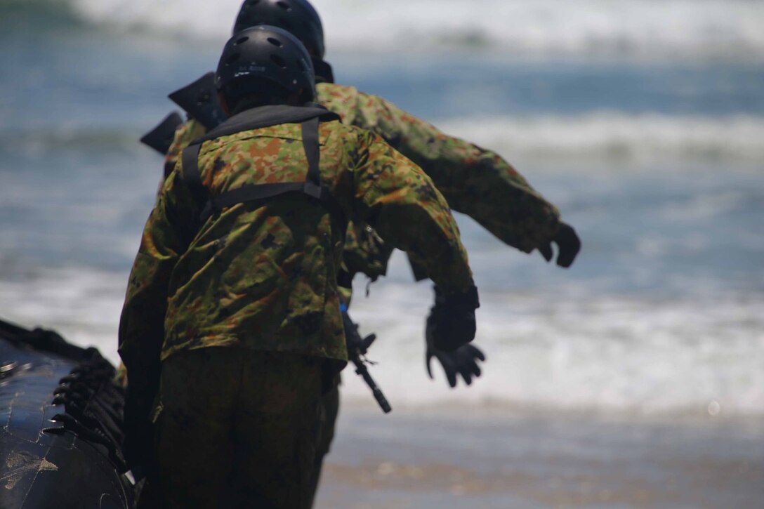 Members of the Japanese Self Defense force prepare to leave the beach during Combat Rubber Rating Craft, better known as CRRC, training here June 4. The purpose of the training was to teach the Japanese forces how to execute amphibious operations from ship to shore.  This training is part of exercise Dawn Blitz, which is mulitnational amphibious exercise that refocuses Navy and Marine Corps and coalition forces in their ability to conduct complex amphibious operations essential for global crisis response across the range of military operations.