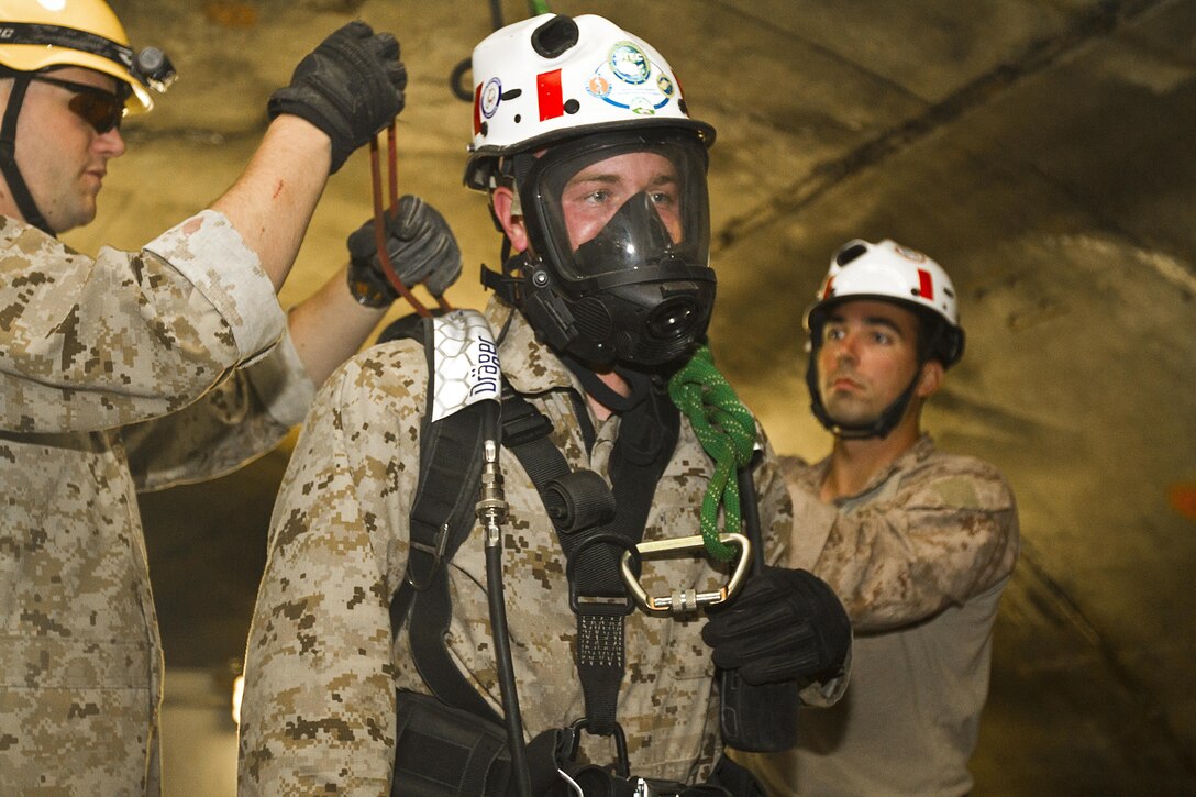 Lance Cpl. Dakota Robinson, 22nd Marine Expeditionary Unit chemical, biological, radiological and nuclear defense specialist and native of Springtown, Texas, prepares to be lowered into the confined-space trainer to search for a casualty at the Center for National Response in Gallagher, W.V., May 30, 2013. A group of 10 Marines and a corpsman from the 22nd MEU completed the 10-day course, which also covered rope rescues and rescue tactics in collapsed structures, May 30 in preparation for the unit’s deployment early next year. (Marine Corps photo by Lance Cpl. Krista James/released)