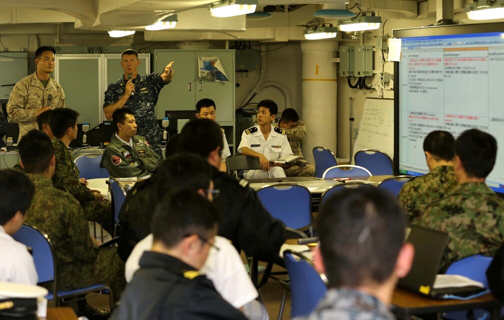 An instructor from the Naval War College talks goes over staff planning with members of the Japanese Self Defense Force during a planning exercise on board the Japanese ship Hyuga at Naval Base San Diego June 7.  The planning exericse gave Marines and sailors a chance share how U.S. ground components and maritime components work together to conduct amphibious operations.  This training is part of Exercise Dawn Blitz, which is scenario-driven exercise that refocuses Navy and Marine Corps and coalition forces in their ability to conduct complex ambibious operations.(Photo by: U.S. Marine Corps Staff Sgt. Jimmy H. Bention, Jr., Public Affairs Chief, 11TH Marine Expeditionary Unit)