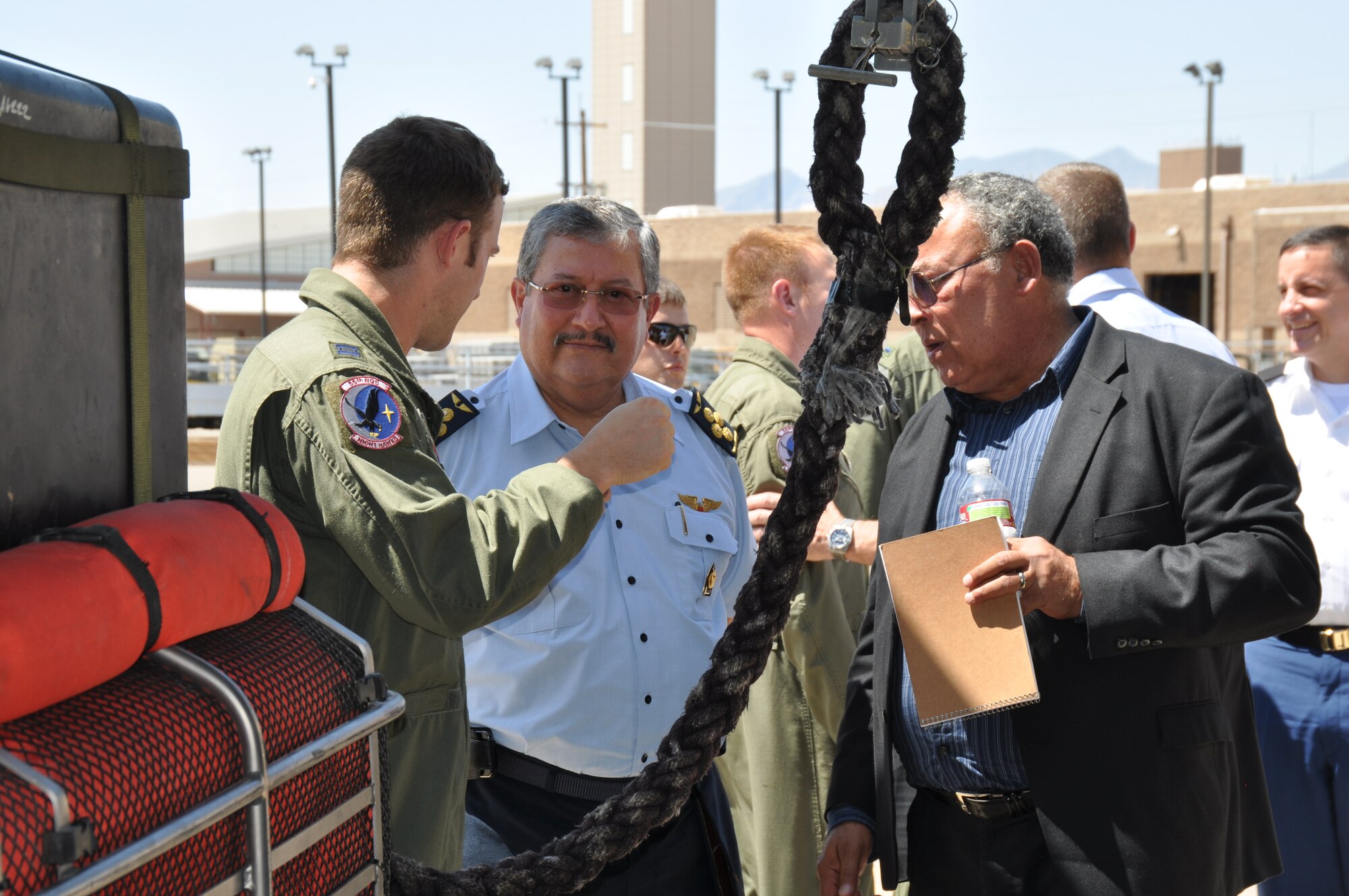 Capt. Danny Bolin, 563rd Rescue Group, explains fast-roping off of an HH-60G Pave Hawk to Air General Jaime Figueroa, Commanding General, Peruvian Air Force, during his visit here, June 10. The Peruvian Air delegation is at D-M for discussions relating to building partnership capacity, countering transnational organized crime, and humanitarian assistance and disaster response in the U.S. Southern Command area of responsibility (USAF photo by Master Sgt. Kelly Ogden/Released).  