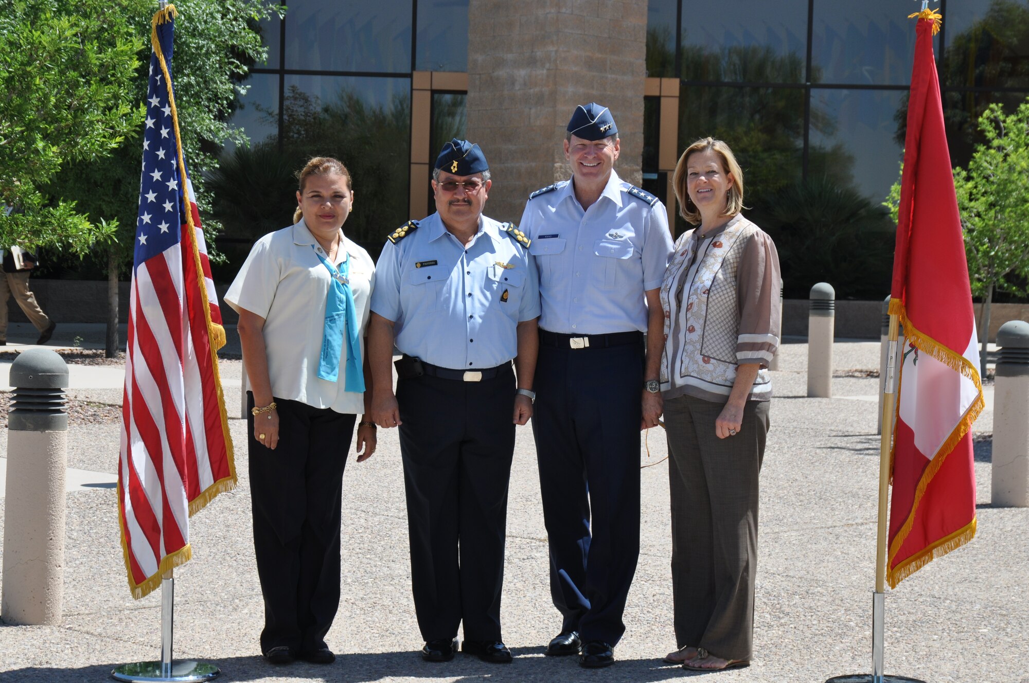 Air General Jaime Figueroa, Commanding General, Peruvian Air Force and his wife, Cecilia, and Lt. Gen. Robin Rand, 12th Air Force (Air Forces Southern) commander, and his wife, Kim, stand next to their respective countries’ flags in front of the 12th Air Force headquarters building here, June 10. The Peruvian Air delegation is at D-M for discussions relating to building partnership capacity, countering transnational organized crime, and humanitarian assistance and disaster response in the U.S. Southern Command area of responsibility (USAF photo by Master Sgt. Kelly Ogden/Released).  