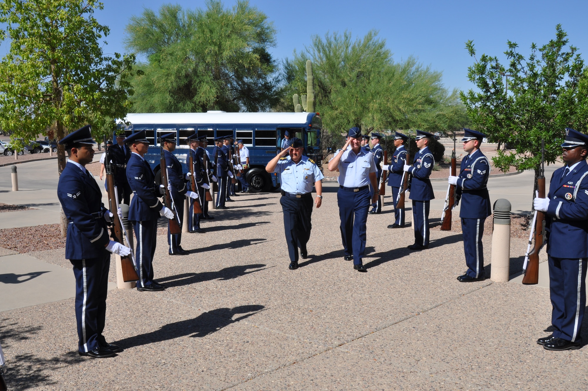 Air General Jaime Figueroa, Commanding General, Peruvian Air Force and Lt. Gen. Robin Rand, 12th Air Force (Air Forces Southern) commander, salute the Davis-Monthan Honor Guard while walking through an honor cordon here, June 10. The Peruvian Air delegation is at D-M for discussions relating to building partnership capacity, countering transnational organized crime, and humanitarian assistance and disaster response in the U.S. Southern Command area of responsibility (USAF photo by Capt. Justin Brockhoff/Released).  