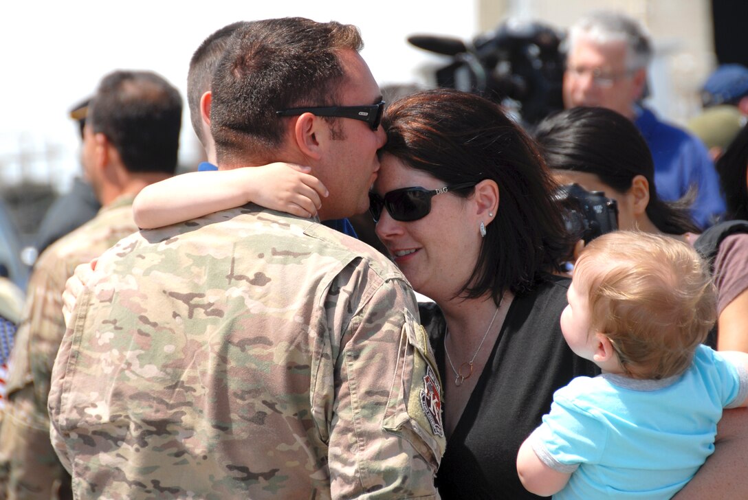 Tech. Sgt. Eric Valdez, a loadmaster assigned with the 130th Rescue Squadron, Moffett Federal Airfield, Calif., is greeted by his family after returning home from a four-month deployment to Afghanistan and Horn of Africa, June 10, 2013. Aircrew members, maintainers and support personnel from the 129th provided combat search and rescue support to Combined Joint Task Force-Horn of Africa and Operation Enduring Freedom in Afghanistan.  (U.S. California Air National Guard photo by Tech. Sgt. Ray Aquino)