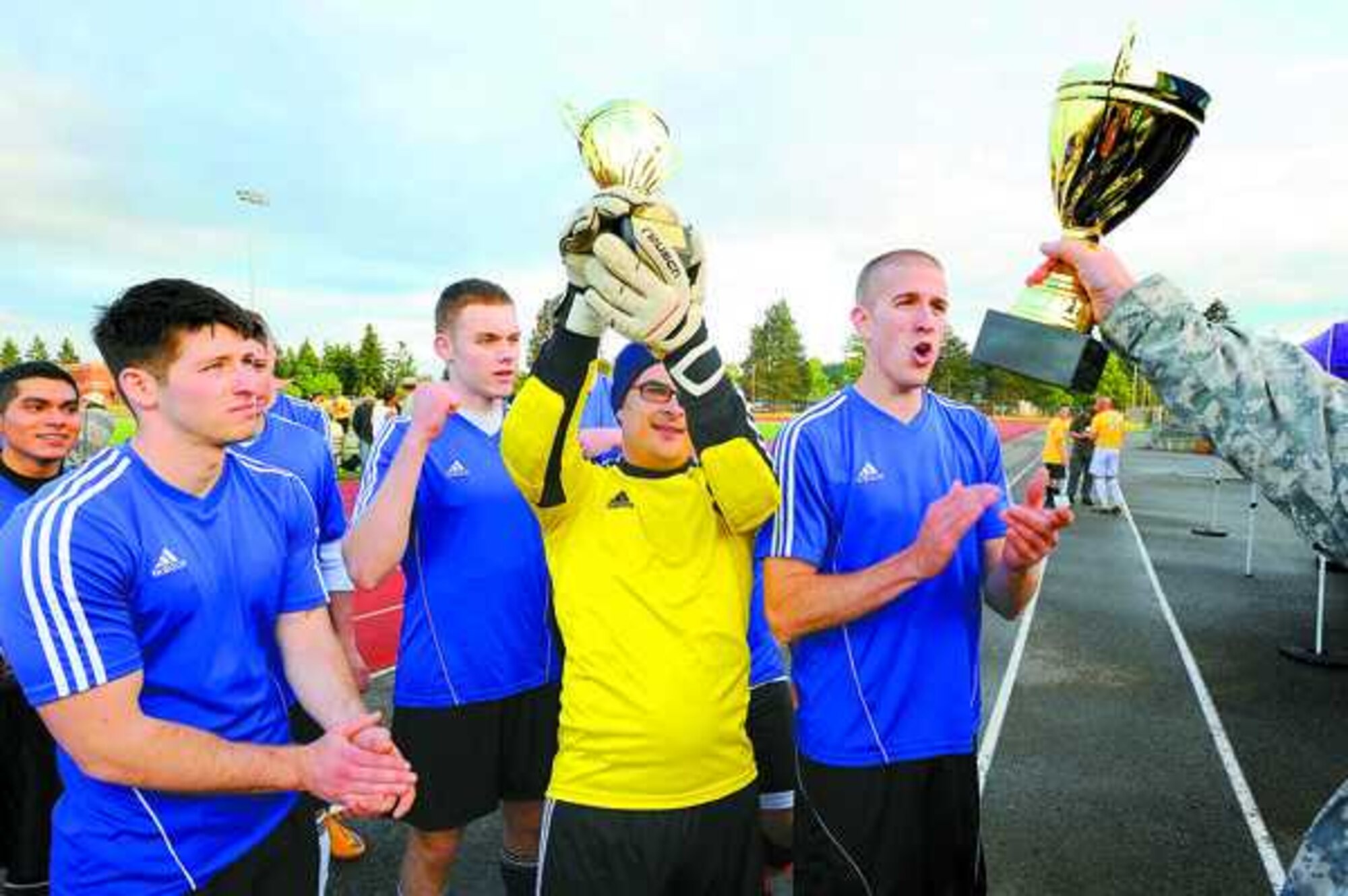 Members of 62nd Aircraft Maintenance Squadron receive their trophies after their 2-1, come-from-behind win over 2nd Brigade Support Battalion, 2nd Infantry Brigade May 22 at Joint Base Lewis-McChord, Wash., during the JBLM Intramural Soccer Championship at Cowan Stadium. (U.S. Army photo/Scott Hansen)