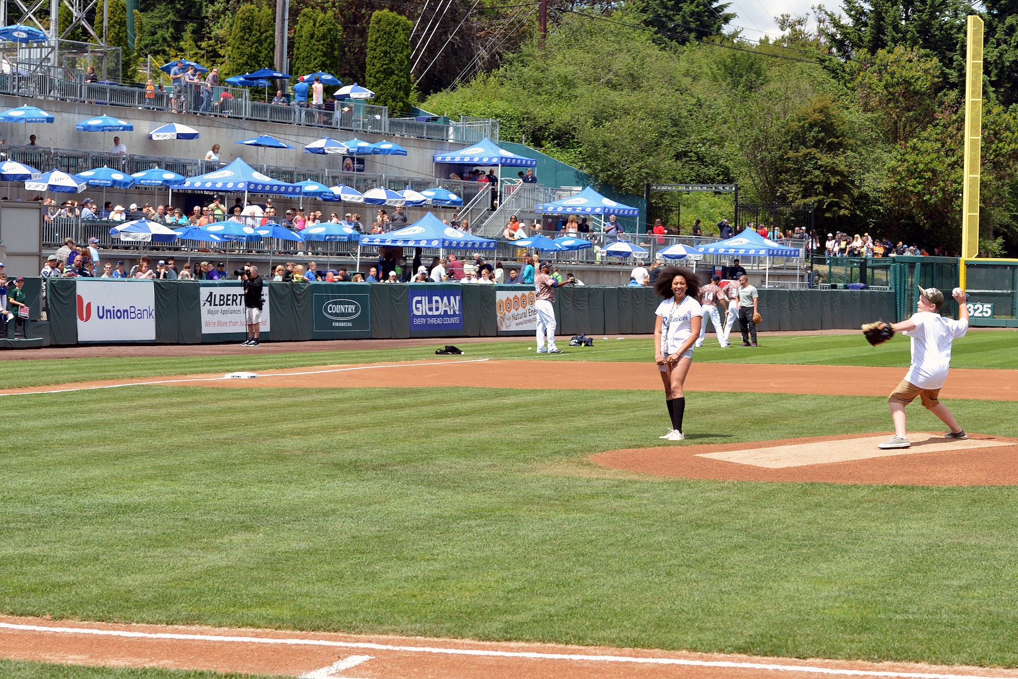 The son of Staff Sgt. Shane Richardson, 62nd Maintenance Squadron NCO in charge of munitions control, from Joint Base Lewis-McChord, Wash., throws the first pitch June 9, 2013 at the Tacoma Rainier’s Salute to Armed Forces game in Tacoma, Wash. Richardson coaches baseball for his son at the McChord Field Youth Center in JBLM. (U.S. Air Force photo/Airman 1st Jacob Jimenez)