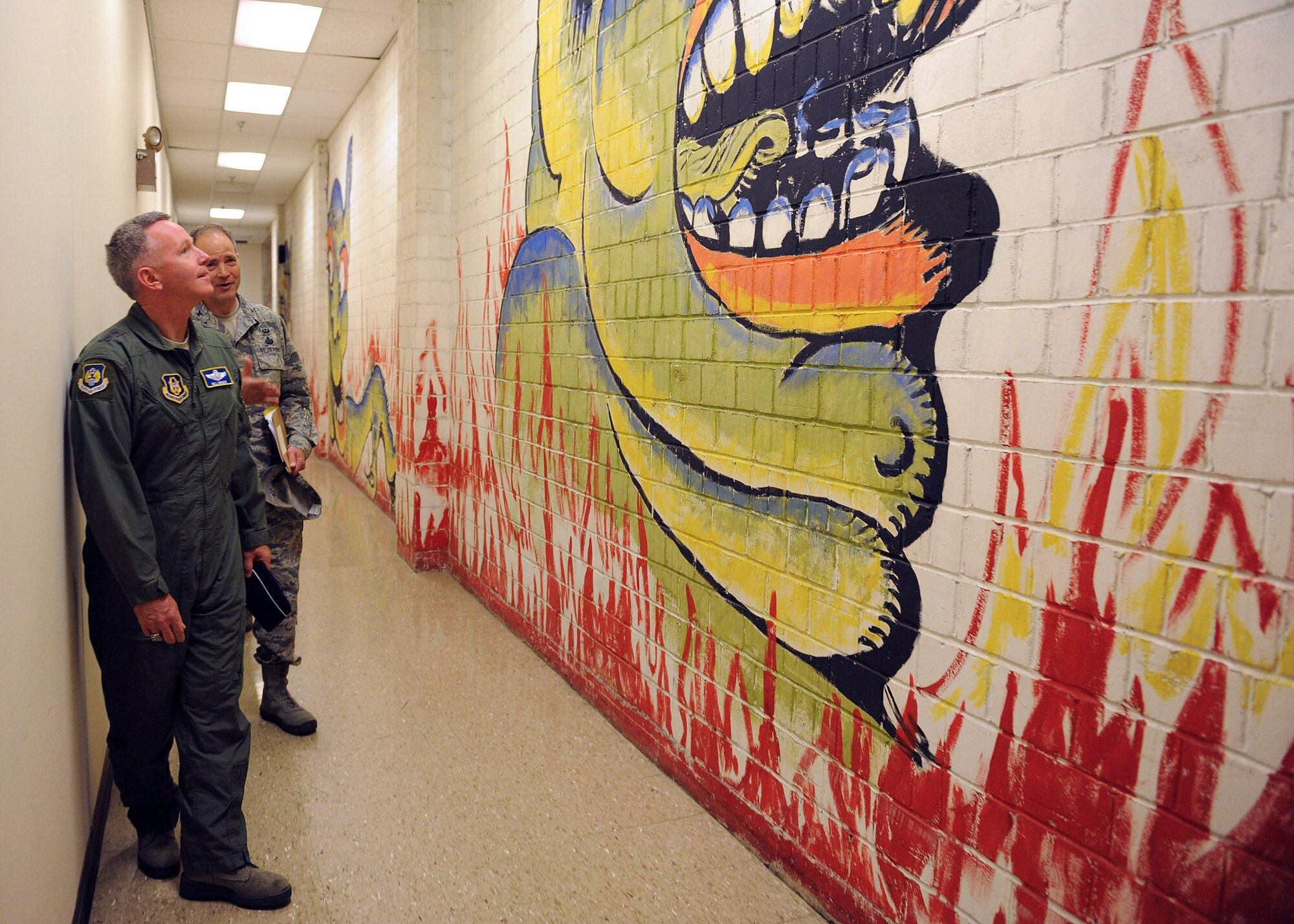 During a recent tour of the 655th ISR Group with Col. Douglas Drakeley, 655th ISR Group commander, Maj. Gen. Bill Binger, 10th Air Force commander, views a mural created in the 1940s by German POWs. (U.S. Air Force photo/Staff Sgt. Veronica A. Pierce)