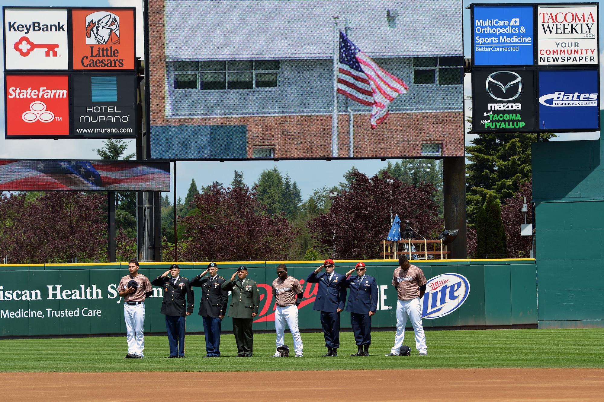 U.S. Army and Air Force servicemembers from Joint Base Lewis-McChord, Wash., salute as the national anthem is played June 9, 2013 at the Tacoma Rainiers Salute to Armed Forces game in Tacoma, Wash. The game honored U.S. servicemembers serving around the world. (U.S. Air Force photo/Airman 1st Jacob Jimenez) 