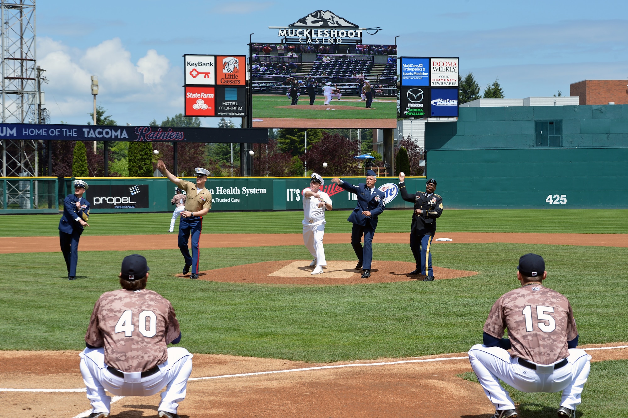 Personnel representing each branch of the military throw the first pitch June 9, 2013 at the Tacoma Rainiers Salute Armed Forces game in Tacoma, Wash. Command Chief Master Sgt. Gordon Drake, 62nd Airlift Wing command chief, took part to represent the Air Force and Joint Base Lewis-McChord, Wash. (U.S. Air Force photo/ Airman 1st Jacob Jimenez)