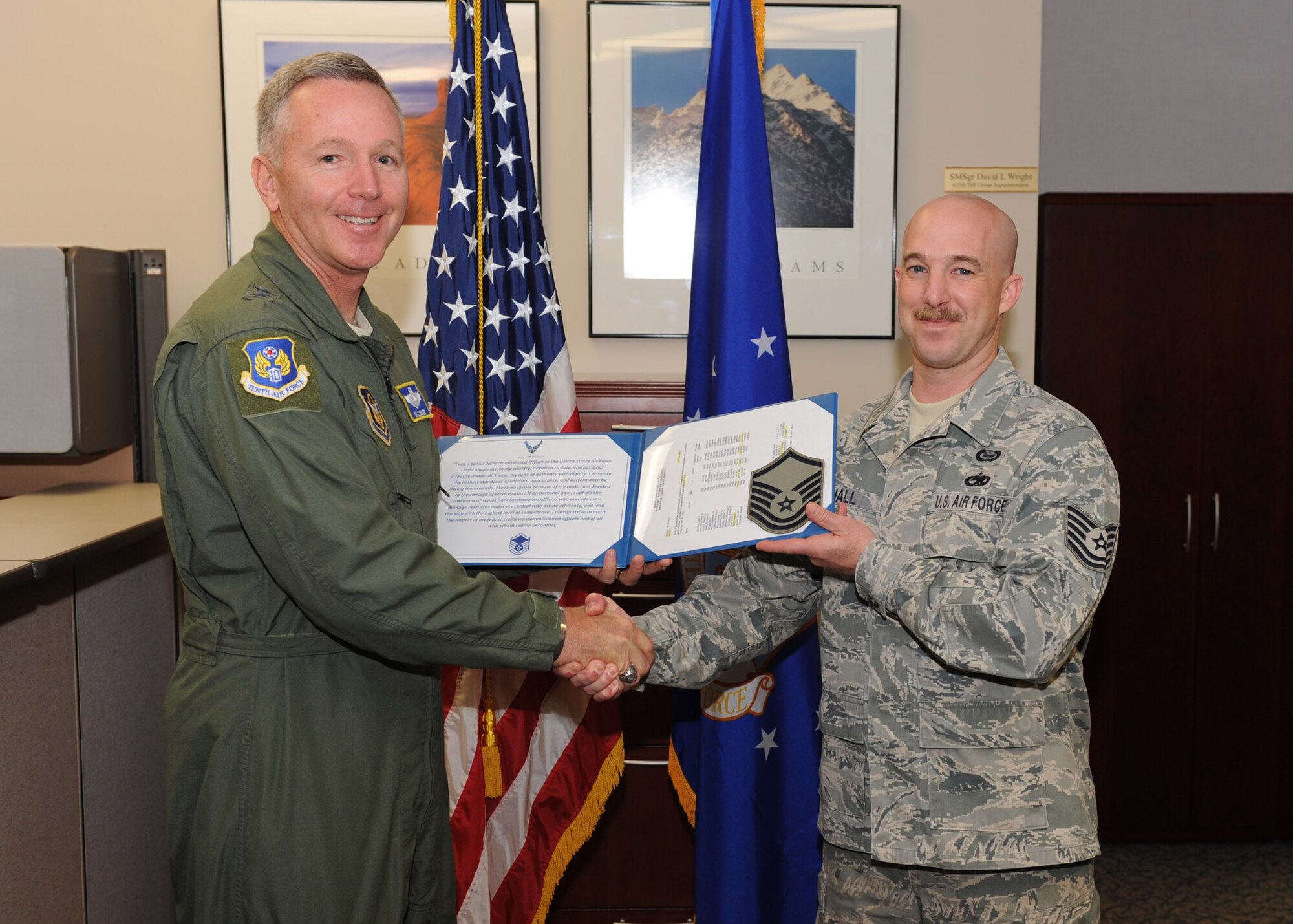 Maj. Gen. Bill Binger, 10th Air Force commander, took a few moments to congratulate the newly promoted Master Sgt. Allen Hall, 655th ISR Group, during his recent visit here. (U.S. Air Force photo/Staff Sgt. Veronica A. Pierce)