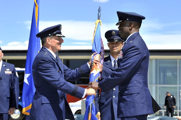 Lt. Gen. Mike Gould (left) hands Col. Stacey Hawkins the guidon during the 10th ABW Change of Command ceremony June 10 at the Air Force Academy. (U.S. Air Force Photo/Raymond McCoy)