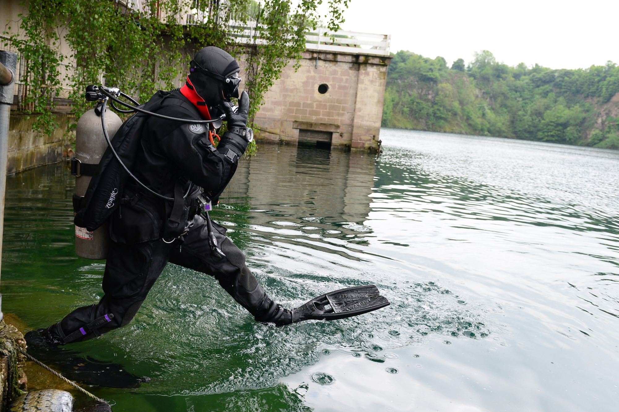 STONEY COVE, England -- Senior Airman Chris Sanders, 56th Rescue Squadron pararescueman, prepares to enter the water during rescue dive training May 30, 2013. The pararescuemen trained in a controlled environment allowing them to focus on their curriculum without being disturbed. Before, during and after the dive, the individuals are briefed, run through scenarios, and perform equipment checks. (U.S. Air Force photo by Senior Airman Lausanne Morgan)