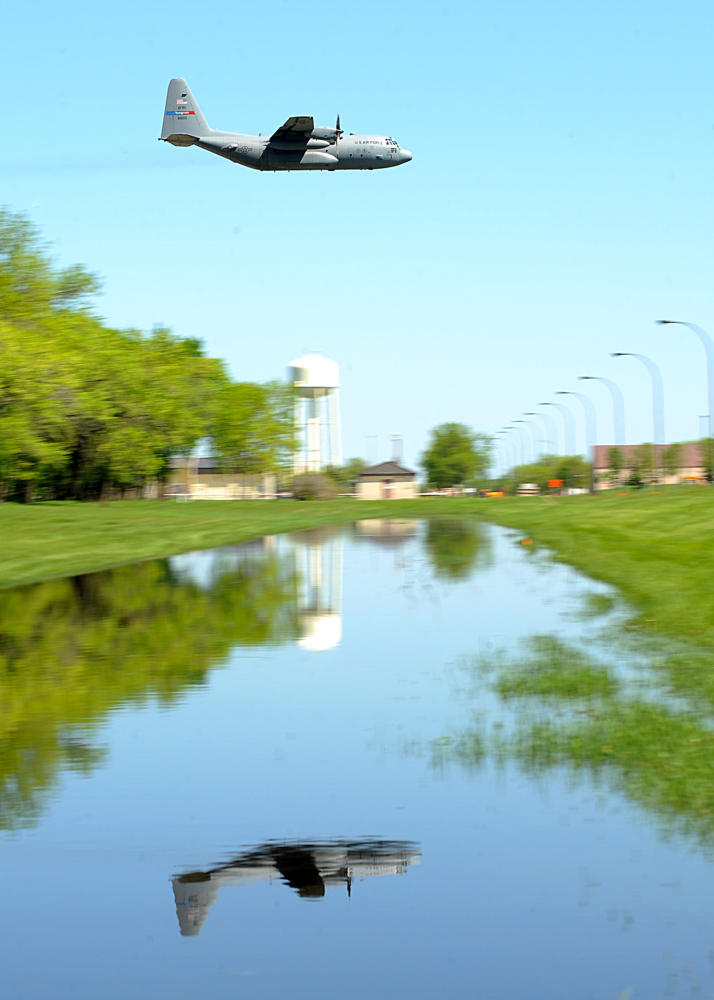 An Air Force Reserve aircrew flying a C-130 Hercules assigned to the 910th Airlift Wing, Youngstown Air Reserve Station, Ohio, sprays a mosquito egg sanitation spray on June 6, 2013, on Grand Forks Air Force Base, N.D. The spray crew is the only one of its kind in the Air Force, assisting multiple bases year-round with their specific area of expertise. (U.S. Air Force photo/Airman 1st Class Xavier Navarro)