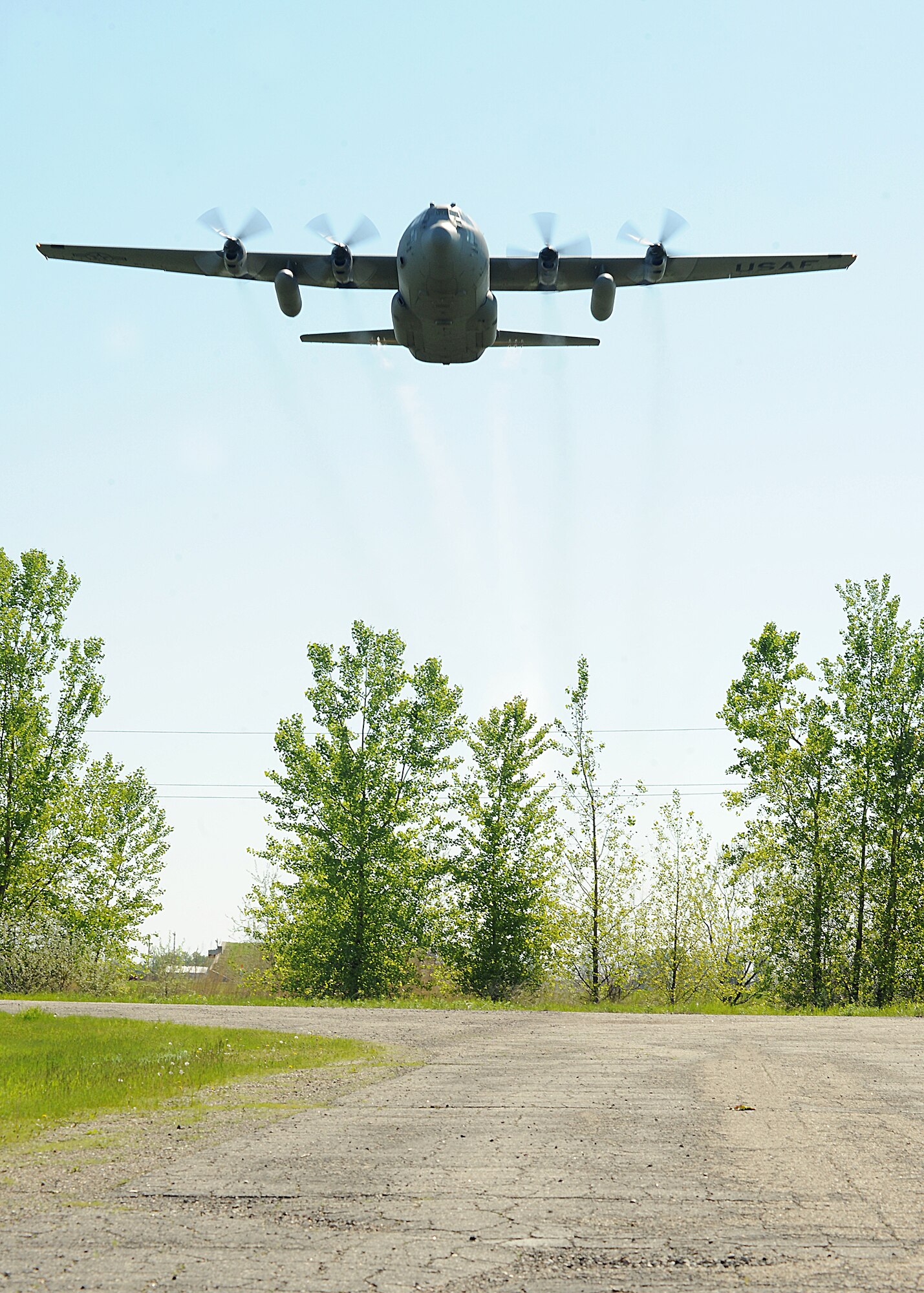 An Air Force Reserve aircrew flying a C-130 Hercules assigned to the 910th Airlift Wing, Youngstown Air Reserve Station, Ohio, sprays a mosquito egg sanitation spray on June 6, 2013, on Grand Forks Air Force Base, N.D. The spray crew is the only one of its kind in the Air Force, assisting multiple bases year-round with their specific area of expertise. (U.S. Air Force photo/Airman 1st Class Zachiah Roberson)