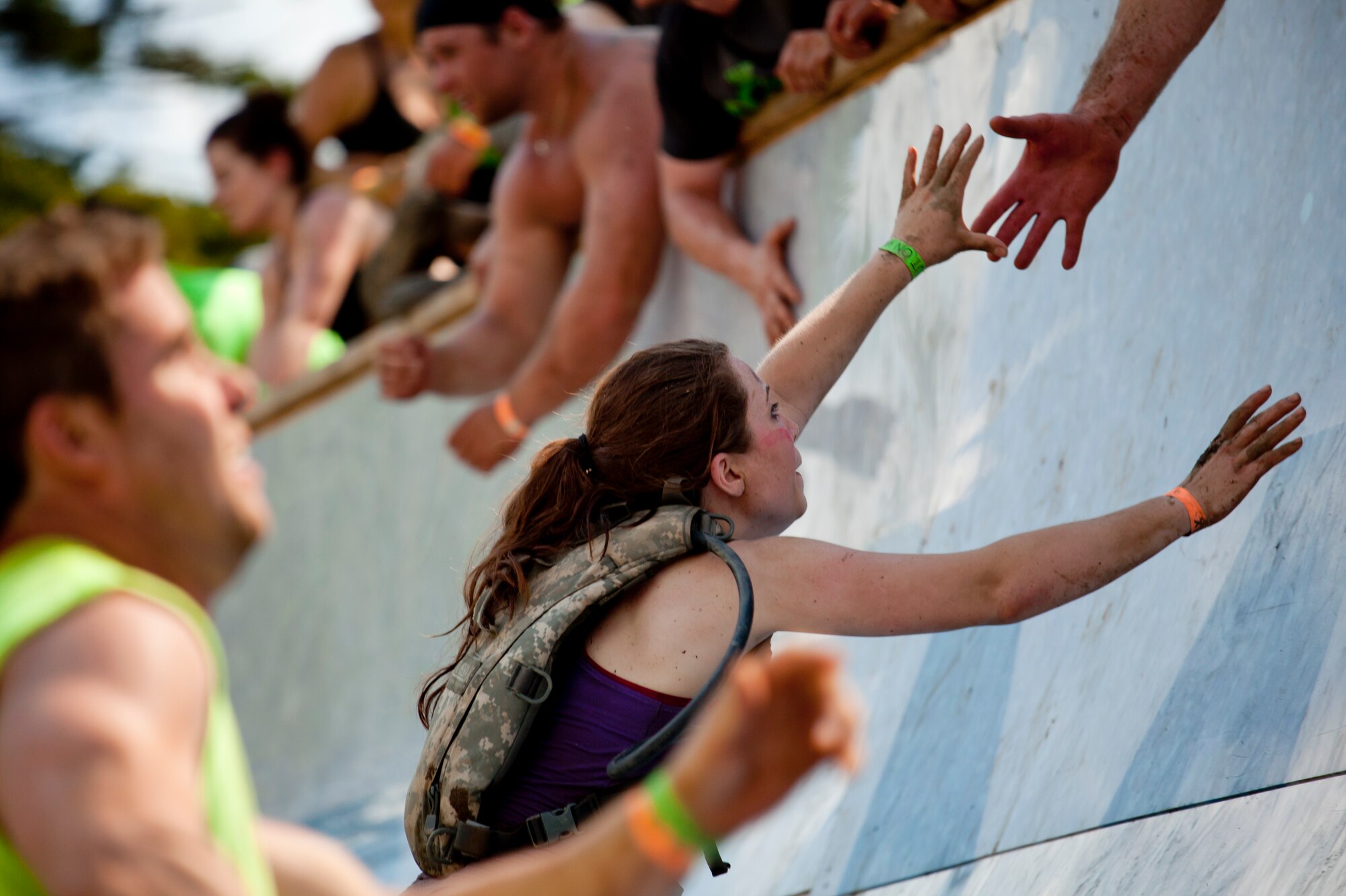 An Airman of the 102nd Medical Group reaches for help while climbing the “Everest” obstacle in Gilford, N.H. on June 1, 2013. Twenty-eight members of the 102nd Intelligence Wing challenged themselves by completing the Boston Tough Mudder event. (National Guard photo by Staff Sgt. Jeremy Bowcock/Released)