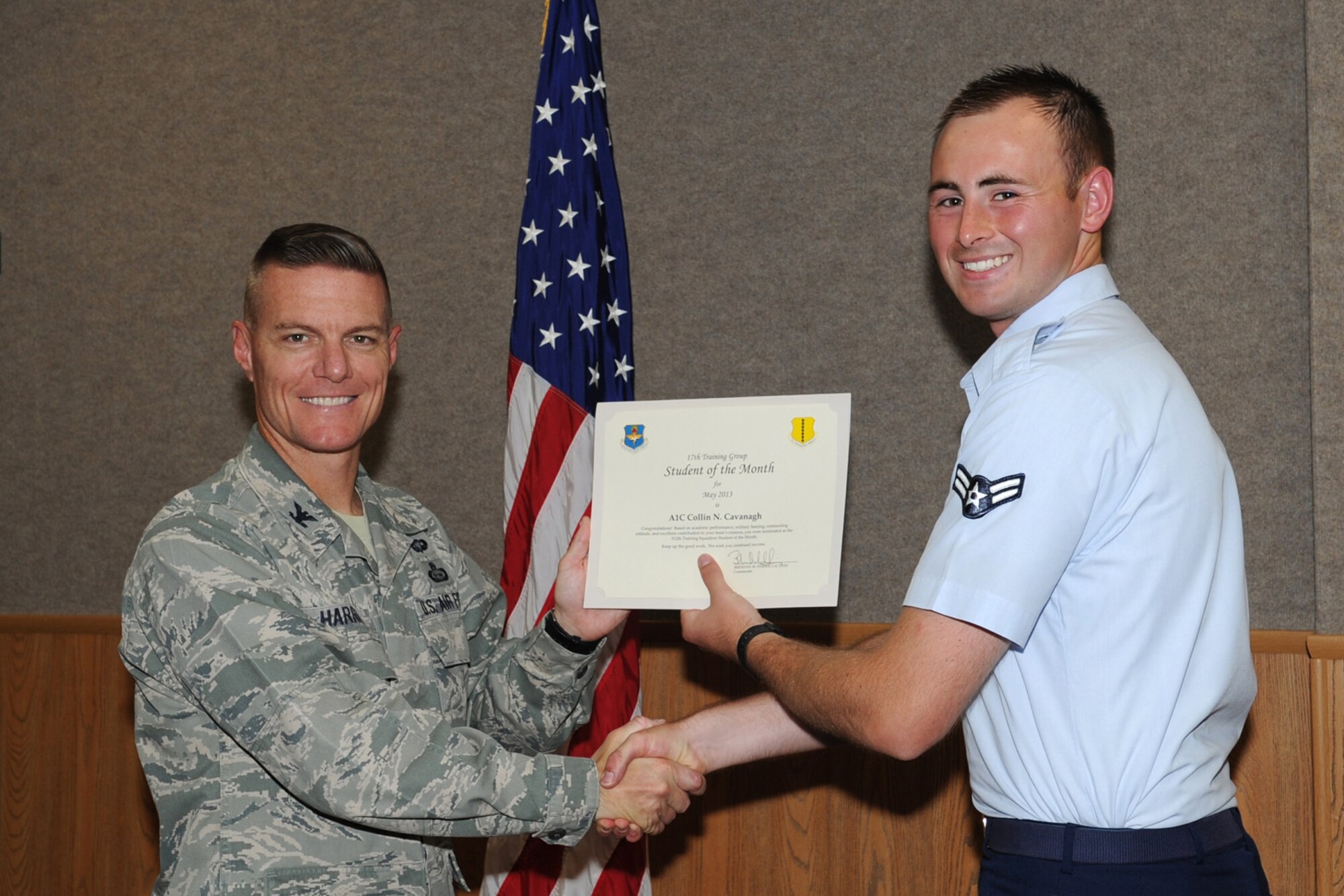 GOODFELLOW AIR FORCE BASE, Texas -- Col. Brendan Harris, 17th Training Group commander, presents the 312th Training Squadron Student of the Month award for May to Airman 1st Class Collin Cavanagh, June 7. (U.S. Air Force photo by Staff Sgt. Laura R. McFarlane)