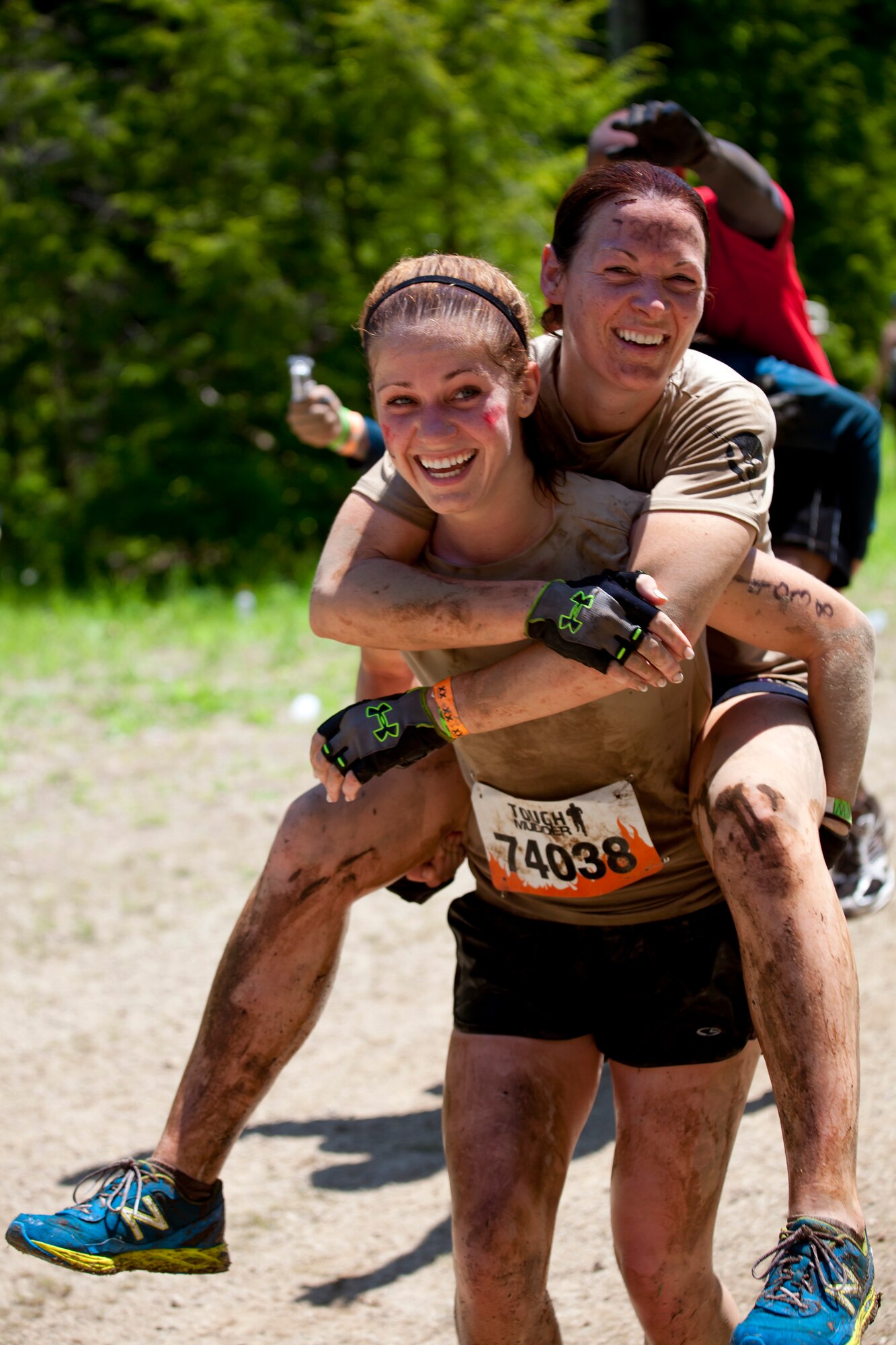 Senior Airman Lindsay Fawcett carries Master Sgt. Gracie Roan, 102nd Intelligence Wing, through the “Wounded Warrior Project carry” obstacle in Gilford, N.H. on June 1, 2013. Twenty-eight members of the 102nd Intelligence Wing challenged themselves by completing the Boston Tough Mudder event. (National Guard photo by Staff Sgt. Jeremy Bowcock/Released)
