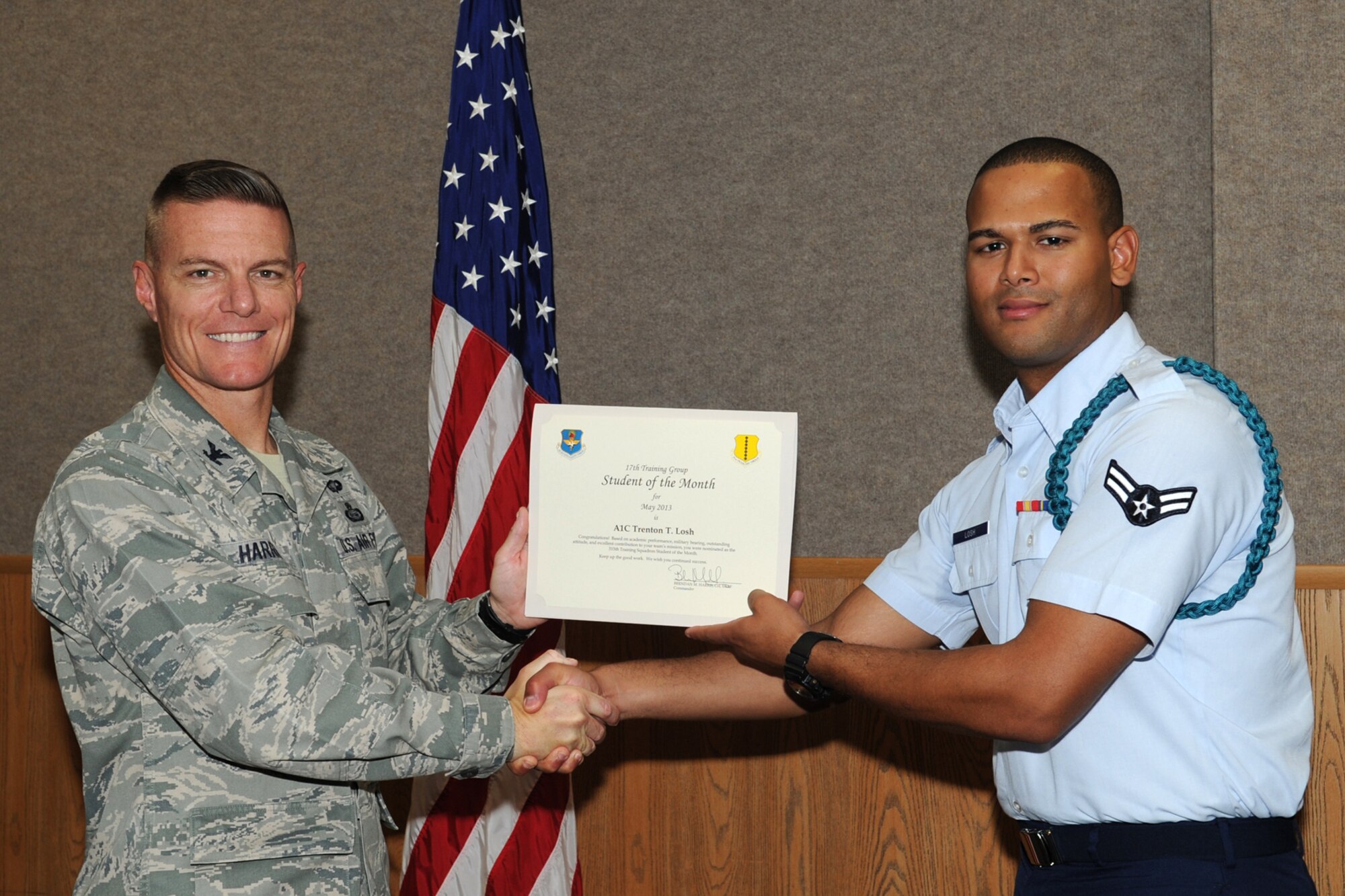 GOODFELLOW AIR FORCE BASE, Texas -- Col. Brendan Harris, 17th Training Group Commander, presents the 315th Training Squadron Enlisted Student of the Month award for May to Airman 1st Class Trenton Losh, June 7. (U.S. Air Force photo/ Staff Sgt. Laura R. McFarlane)