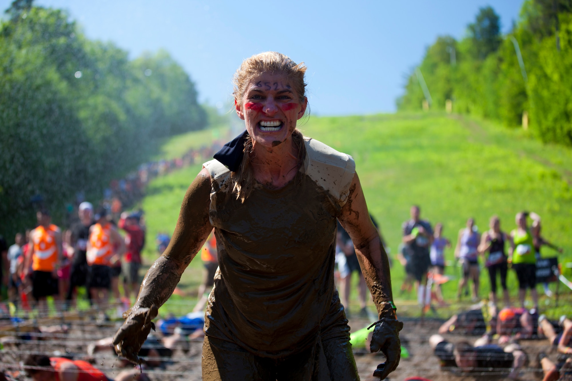 Col. Virginia Doonan, 102nd Intelligence Group commander, poses after crawling through the mud at Gilford, N.H. on June 1, 2013. Twenty-eight members of the 102nd Intelligence Wing challenged themselves by completing the Boston Tough Mudder event. (National Guard photo by Staff Sgt. Jeremy Bowcock/Released)