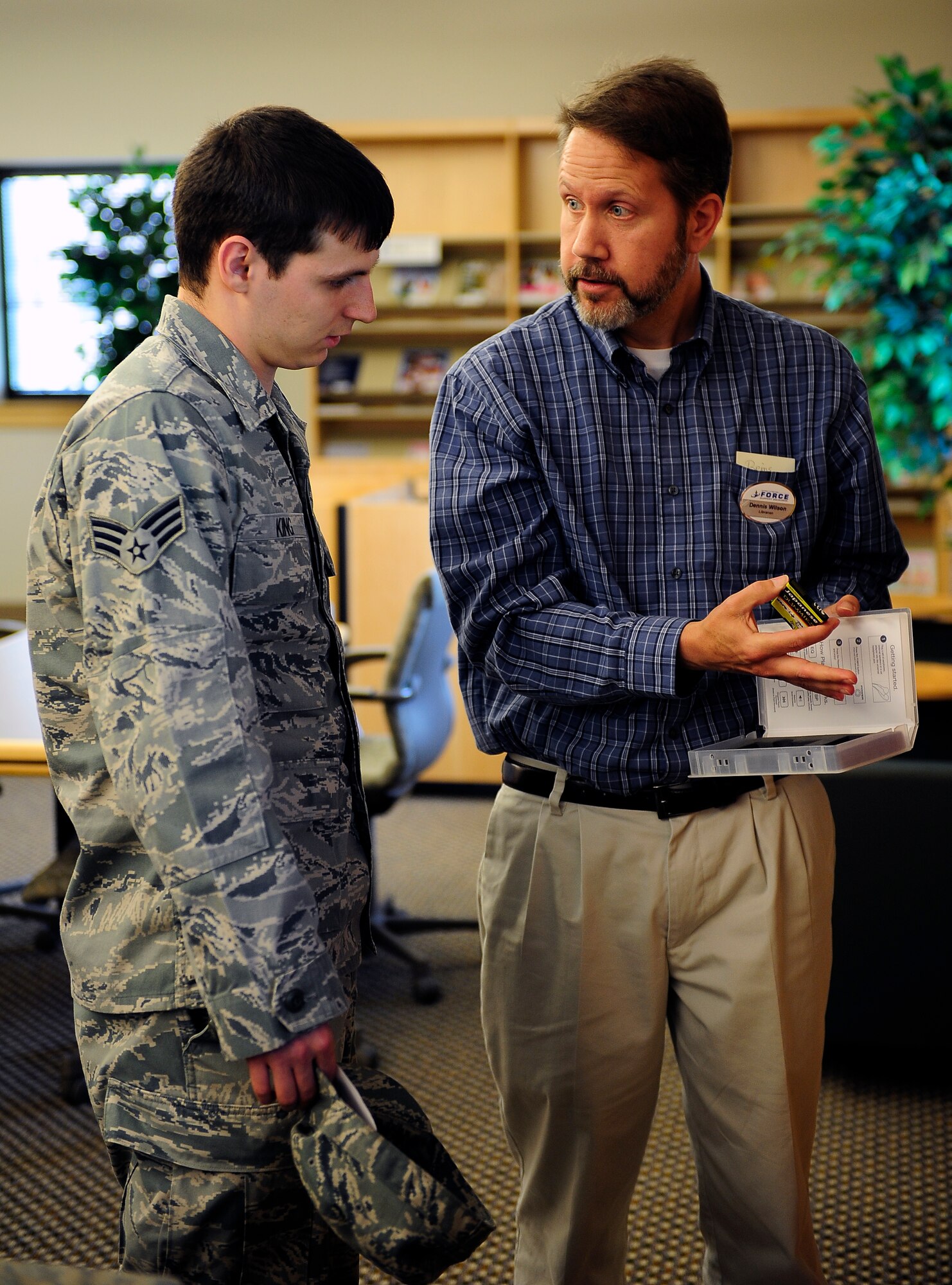Senior Airman Matthew King, 509th Communications Squadron intrusion detection technician, learns about the different programs available for learning Japanese from Dennis Wilson, 509th Force Support Squadron supervisory librarian, at the library at Whiteman Air Force Base, Mo., May 23, 2013. King has long been a fan of Japanese anime and is looking to learn more about the Japanese culture. (U.S. Air Force photo by Airman 1st Class Shelby R. Orozco/Released)