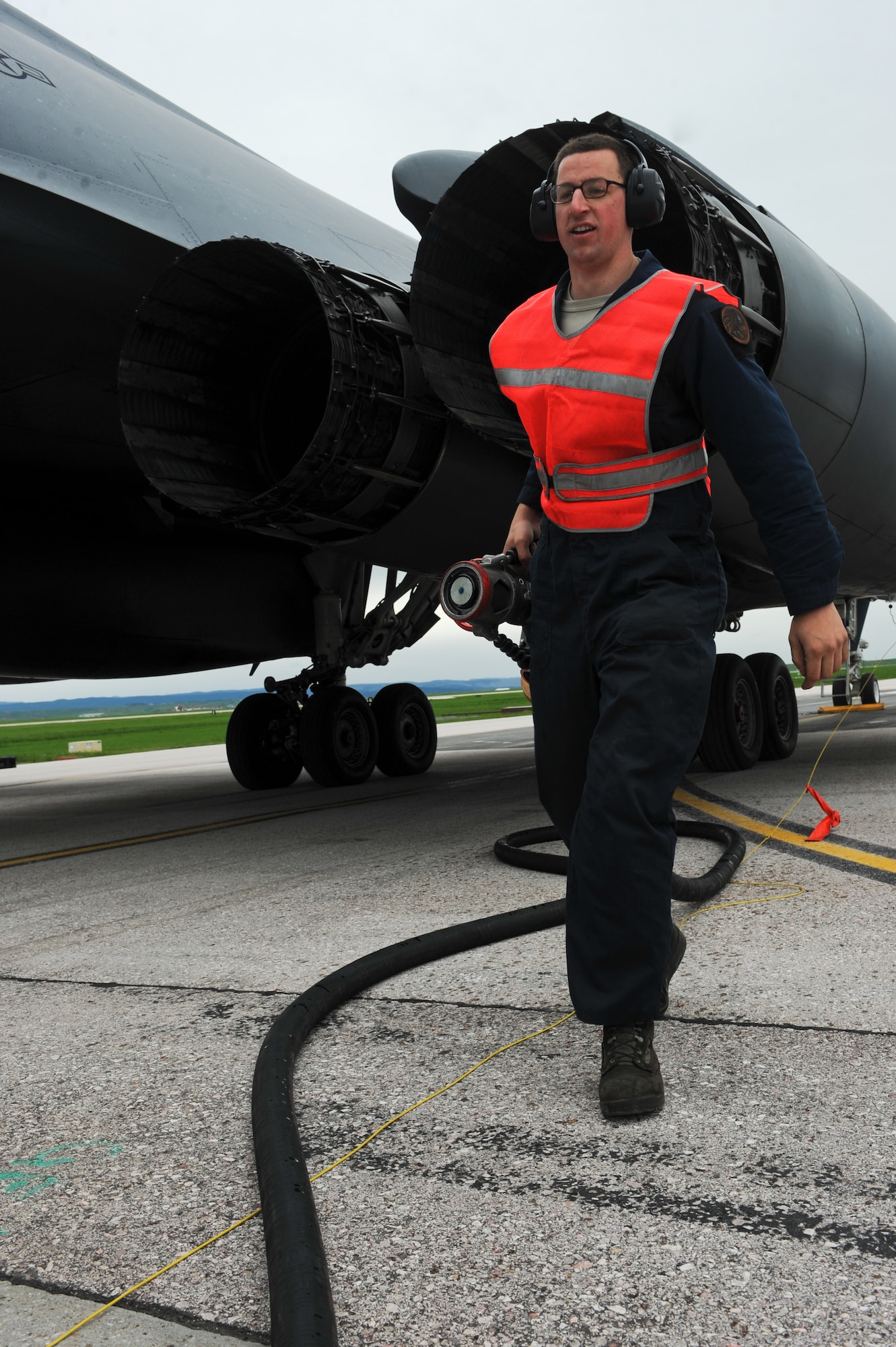 Senior Airman Matthew McFarlan, 28th Aircraft Maintenance Squadron B-1 bomber crew chief, detaches a fuel hose after hotpit refueling a B-1 from Dyess Air Force Base, Texas on the flightline at Ellsworth AFB, S.D., May 31, 2013. Hot pit refueling, usually performed in a combat environment, is a carefully controlled process during which two engines continue running, reducing maintenance down time for the aircraft. (U.S. Air Force photo by Senior Airman Kate Maurer/Released)