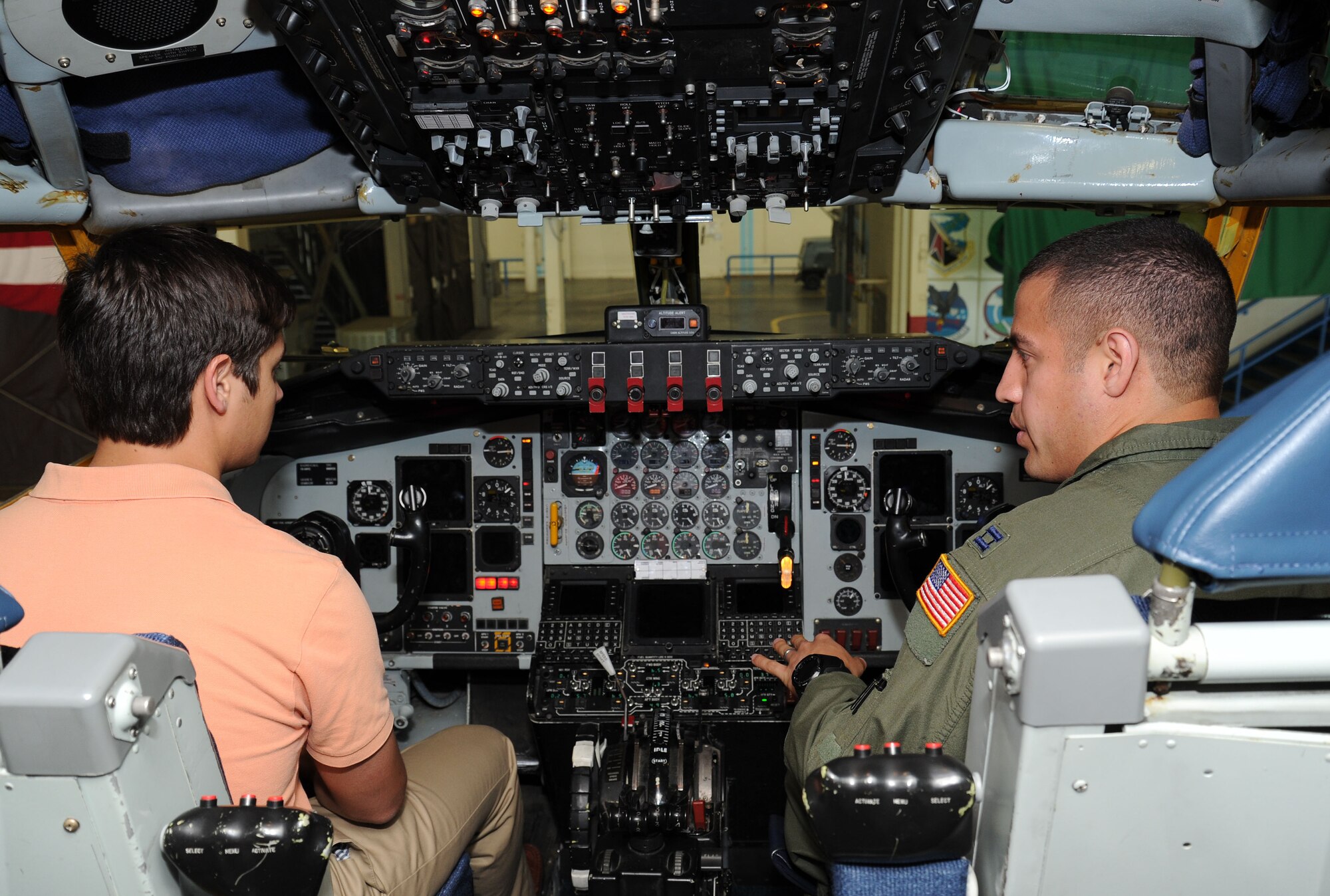 Capt. Robert Colby, 93rd Air Refueling Squadron pilot, shows a Society of American Indian Government Employee student how to fly a KC-135 Stratotanker as part of a tour at Fairchild Air Force Base, Wash., June 4, 2013. Fairchild conducted a base tour which consisted of 20 SAIGE students from all over the country. (U.S. Air Force photo by Airman 1st Class Janelle Patiño/Released)