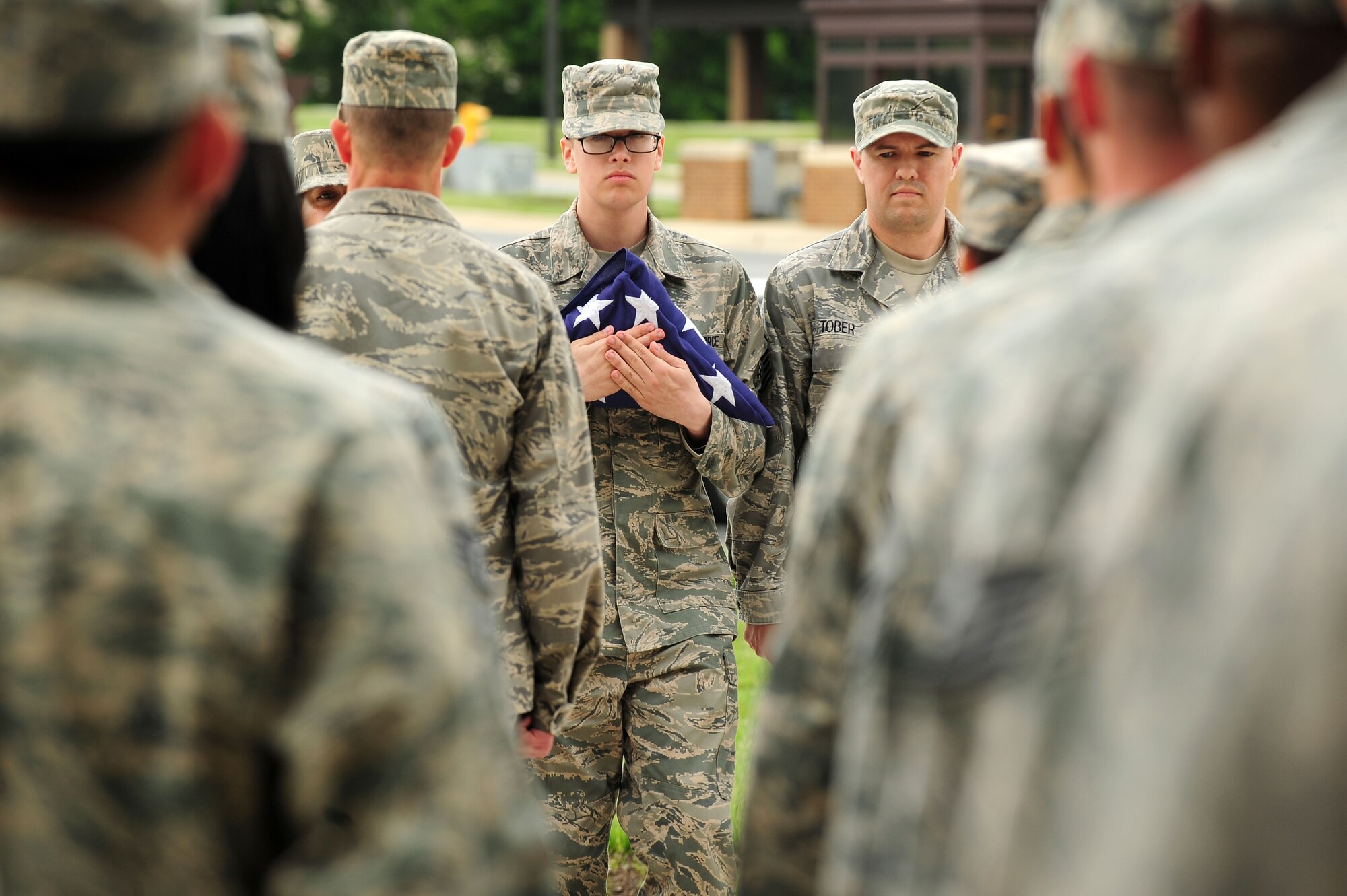 Airman 1st Class Seth Topping and fellow Headquarters Air Force District of Washington Staff Airmen participate in a retreat ceremony, June 6, 2013, at Joint Base Andrews, Md. Remembering the 160,000 Allied troops that landed along a 50-mile stretch of heavily-fortified French coastline to fight Nazi Germany on the beaches of Normandy, France, AFDW Vice Commander Michael E. Gantt read a speech that Gen. Dwight D. Eisenhower gave stating ?we will accept nothing less than full victory.? (U.S. Air Force photo by Senior Airman Steele C. G. Britton)