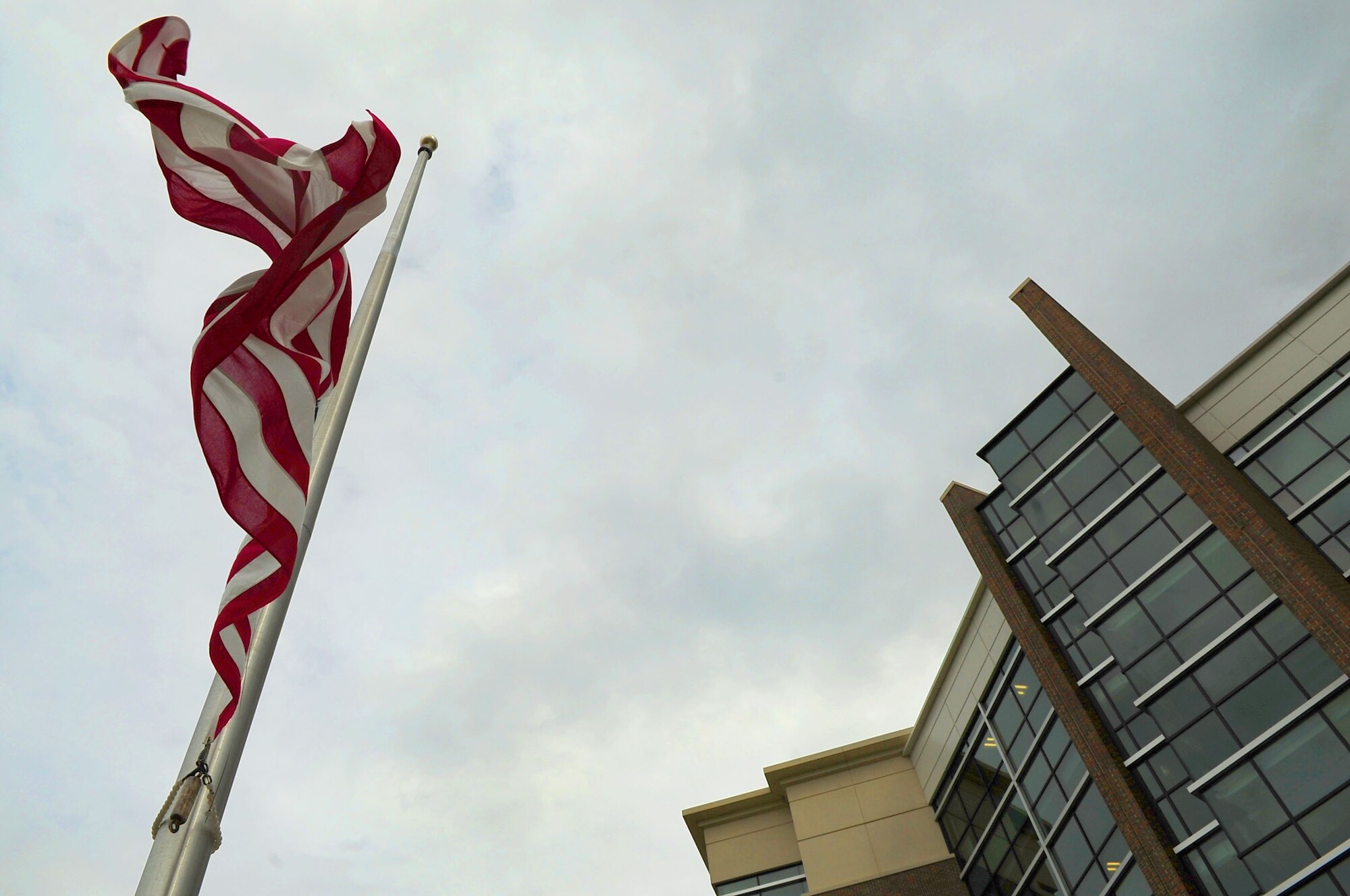 The American flag lowers at the Jones Building during a retreat ceremony conducted by Headquarters Air Force District of Washington Staff Airmen, June 6, 2013, at Joint Base Andrews, Md. The Airmen honored the anniversary of D-Day when 160,000 Allied troops landed along a 50-mile stretch of heavily-fortified French coastline to fight Nazi Germany on the beaches of Normandy, France. More than 5,000 ships and 13,000 aircraft supported the D-Day invasion, and by day?s end on June 6, the Allies gained a foot- hold in Normandy. (U.S. Air Force photo by Senior Airman Steele C. G. Britton)